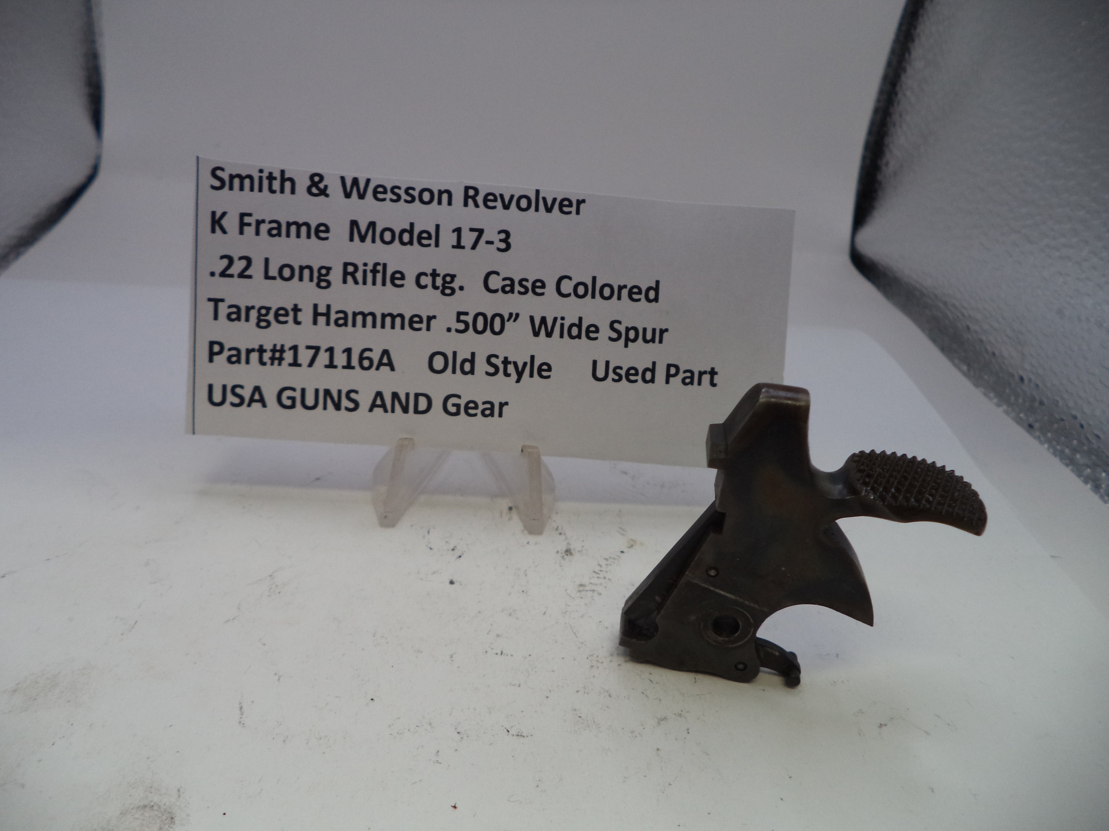Smith & Wesson revolver part on a white surface with a label