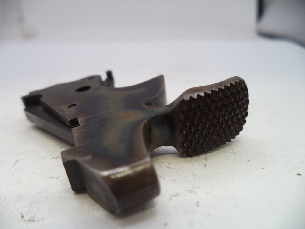 Brown plastic component with textured surface on a white background