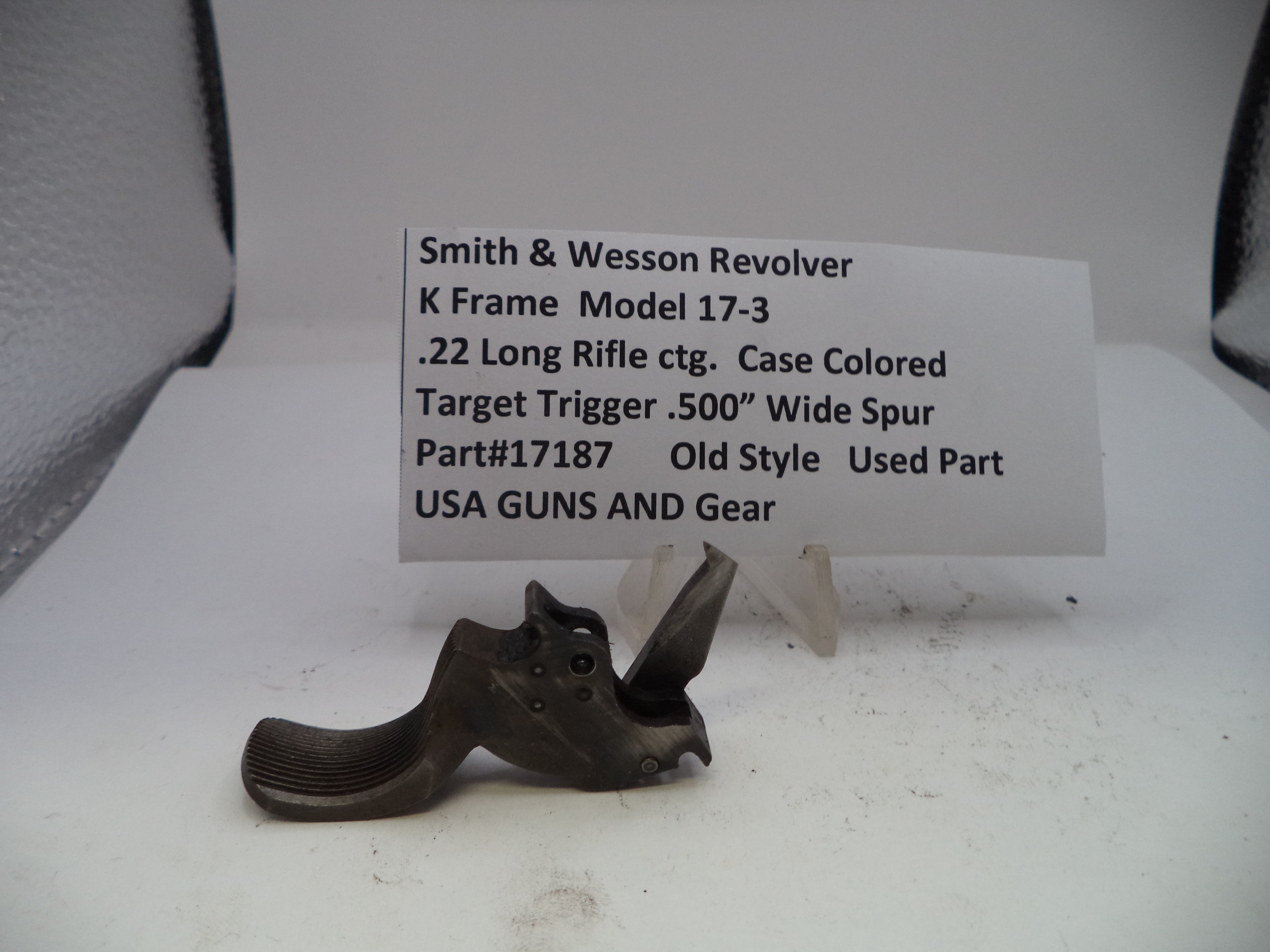 Smith & Wesson revolver part on a white background with descriptive text card.