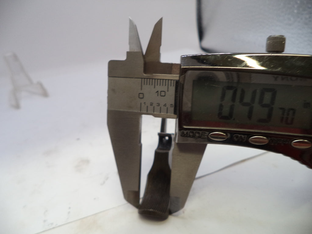 Digital caliper measuring a small metal object on a white background