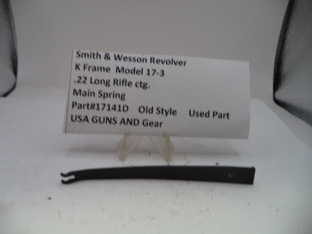 Black main spring for a Smith & Wesson revolver on a white background with a label.