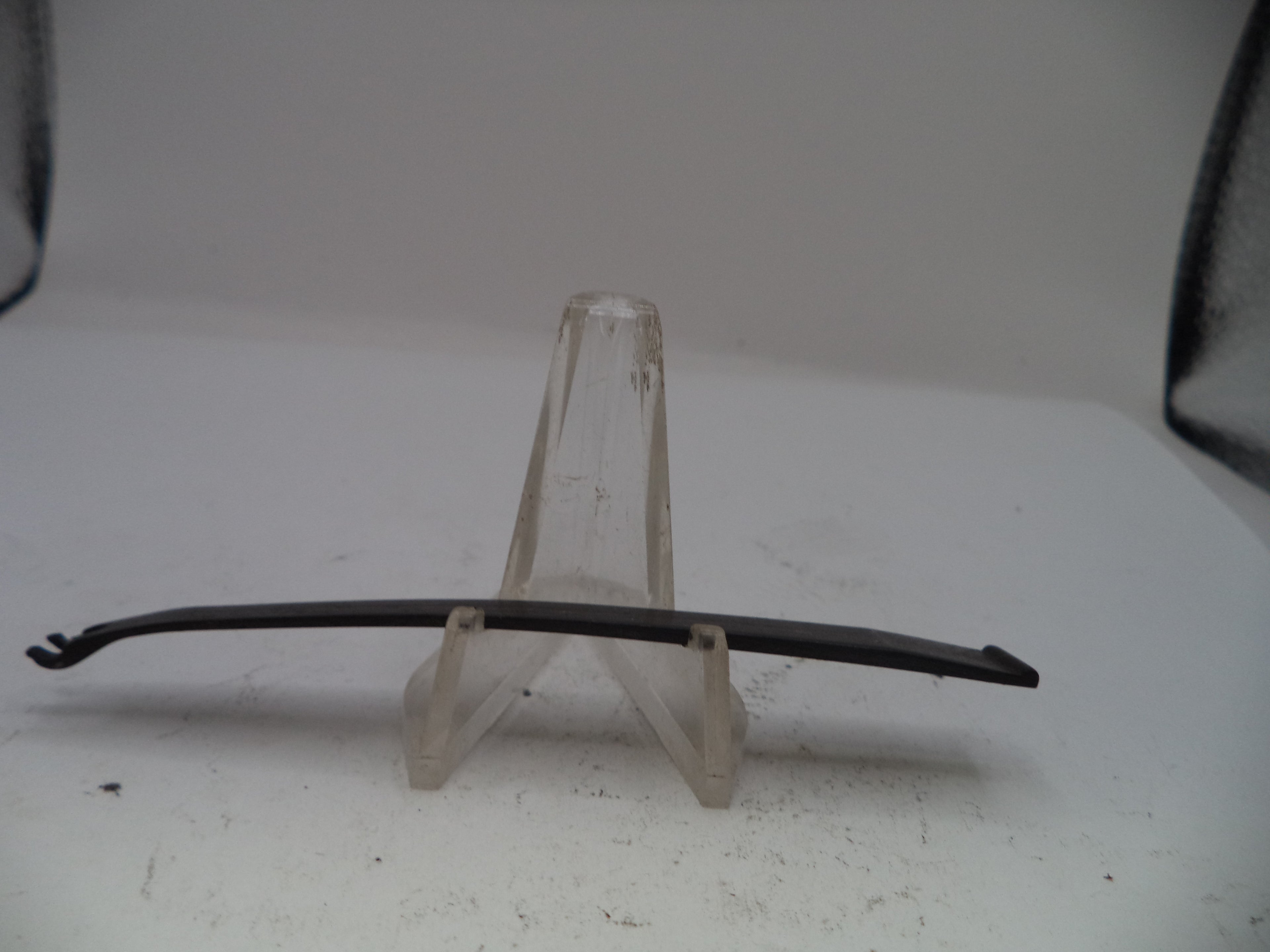 Metal rod on a clear stand against a white background