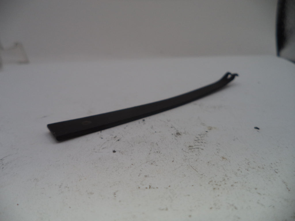Black metal bar on a white surface with visible dirt