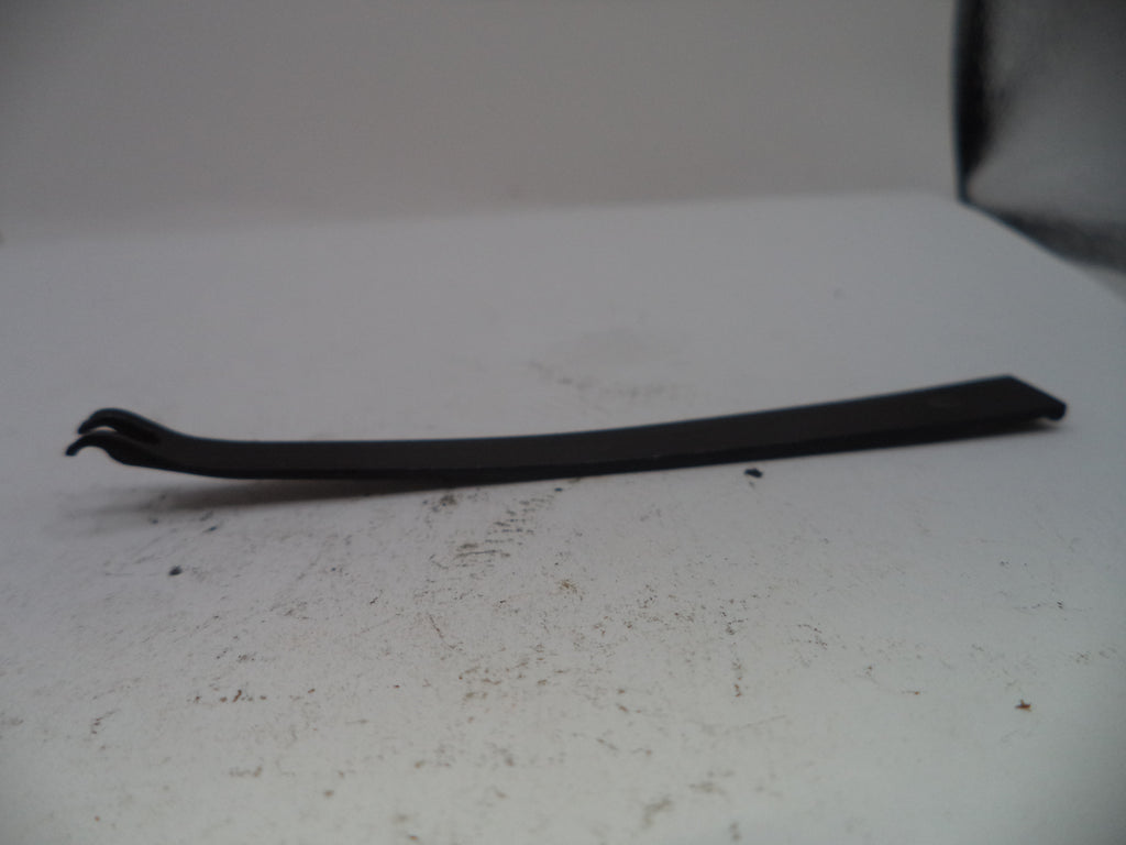Black metal tool on a white surface with a blurred background