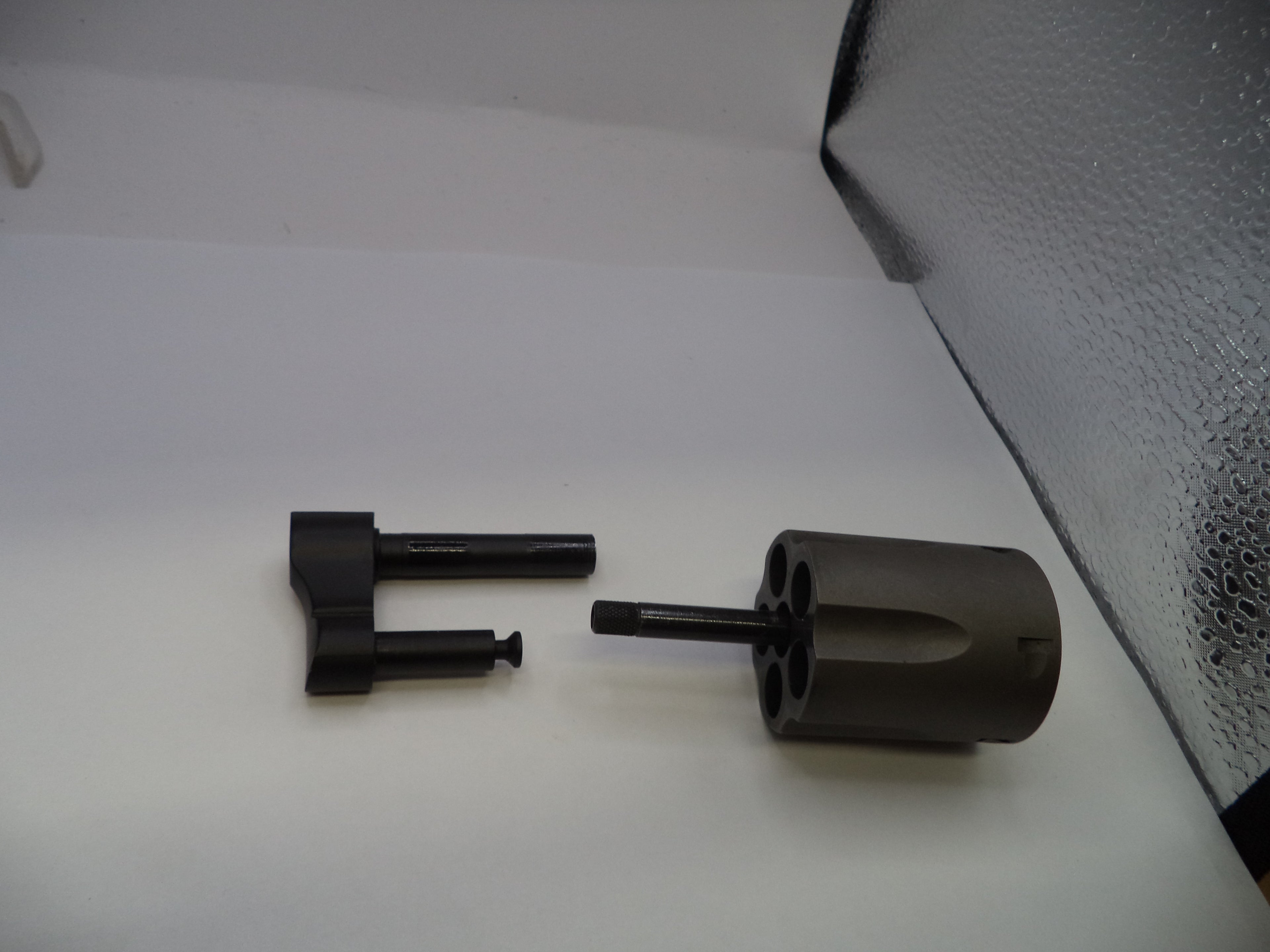 Two black metal components on a white surface