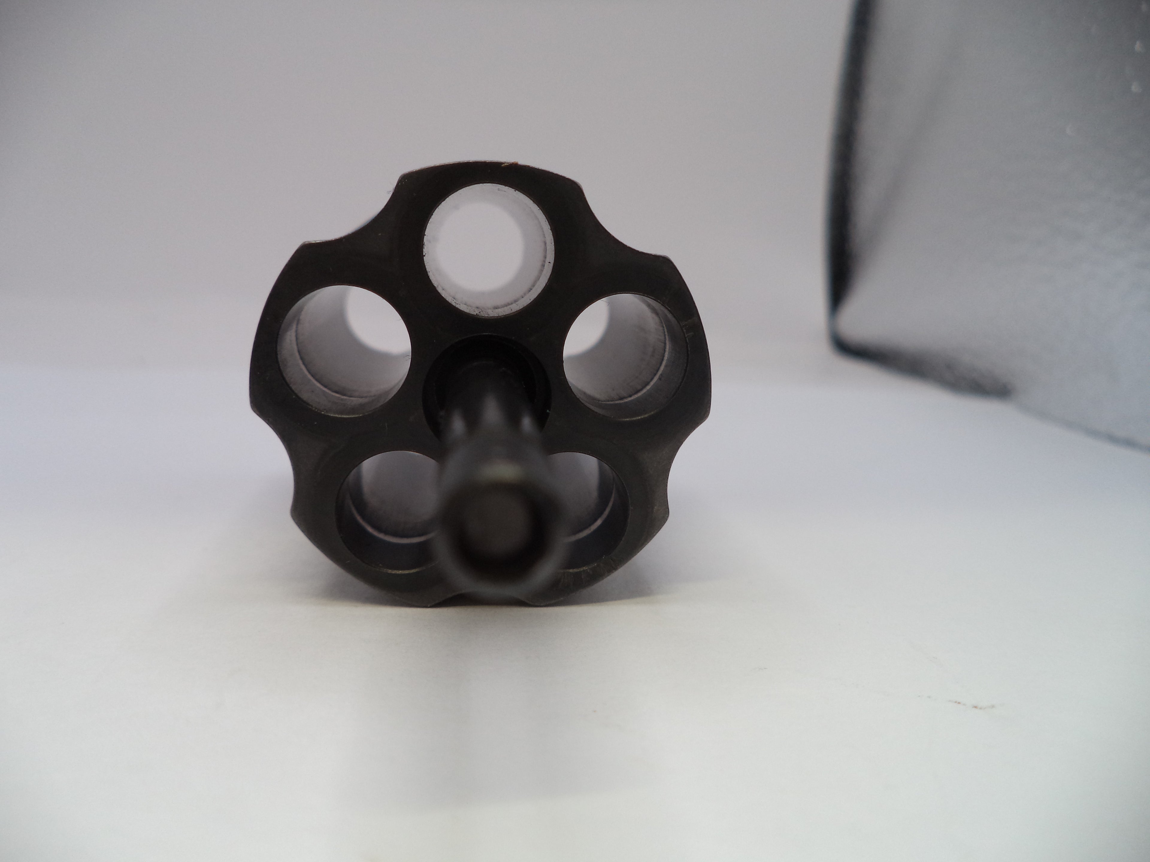 Black metal knurled knob on a white background