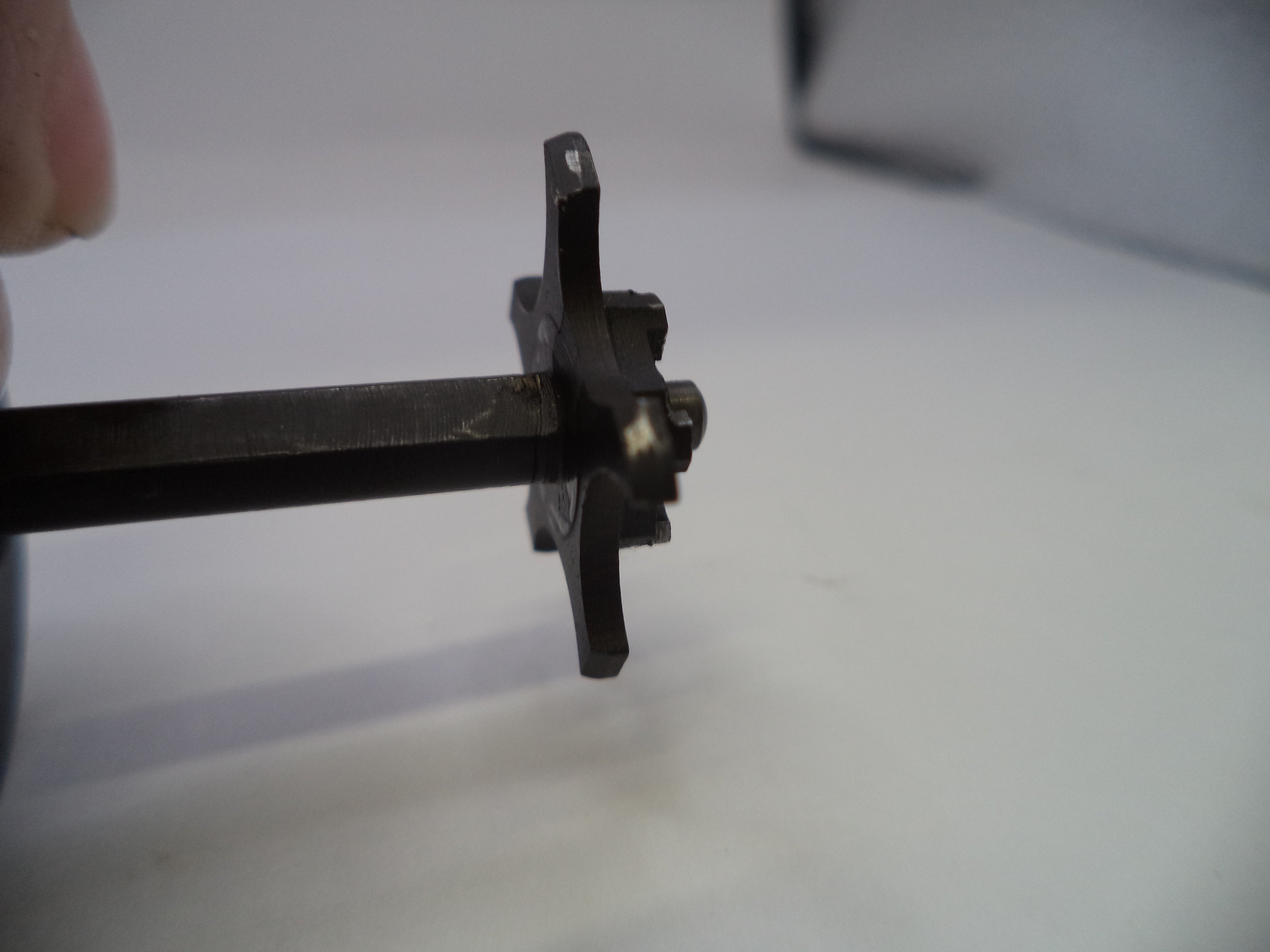 Metal tool or component on a white background
