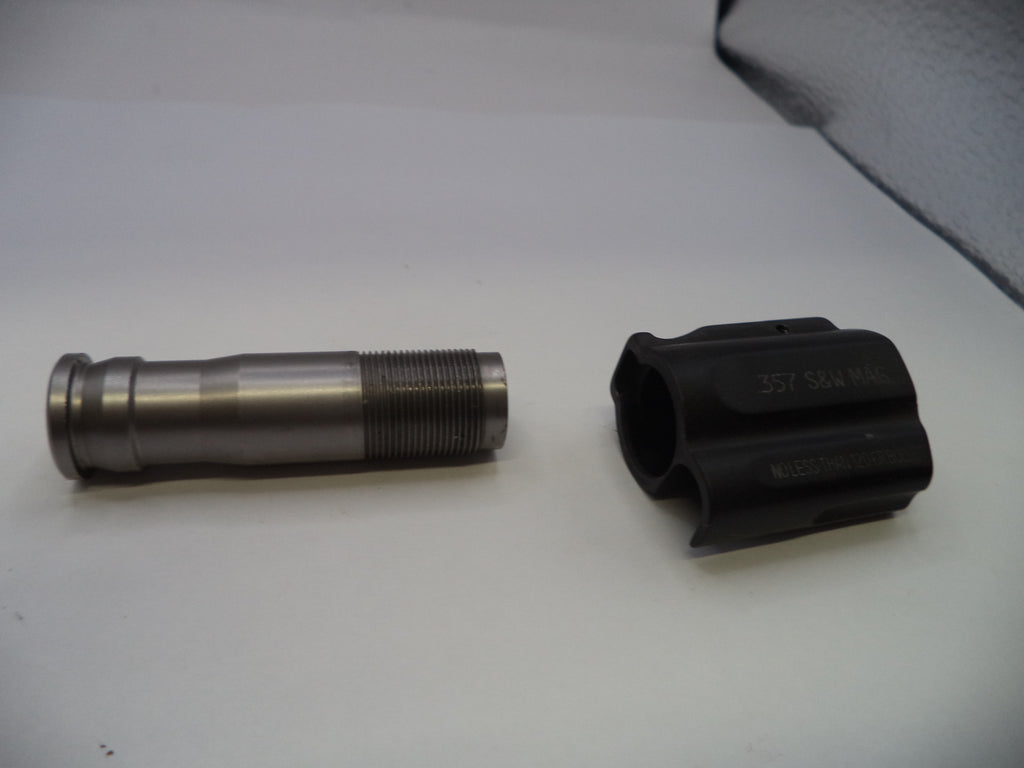 Two metal components on a white surface