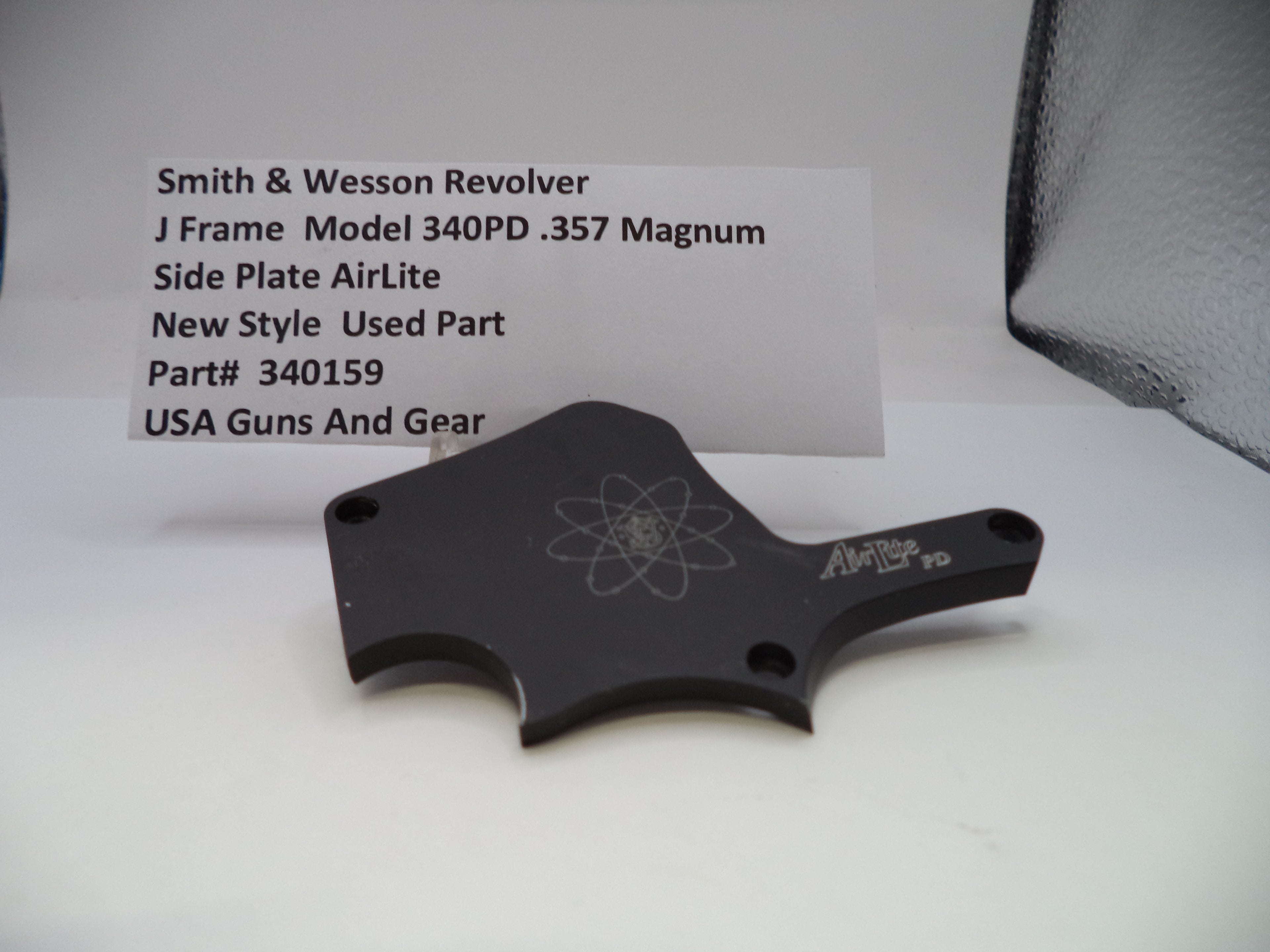 Black side plate for a Smith & Wesson revolver on a white background with text.