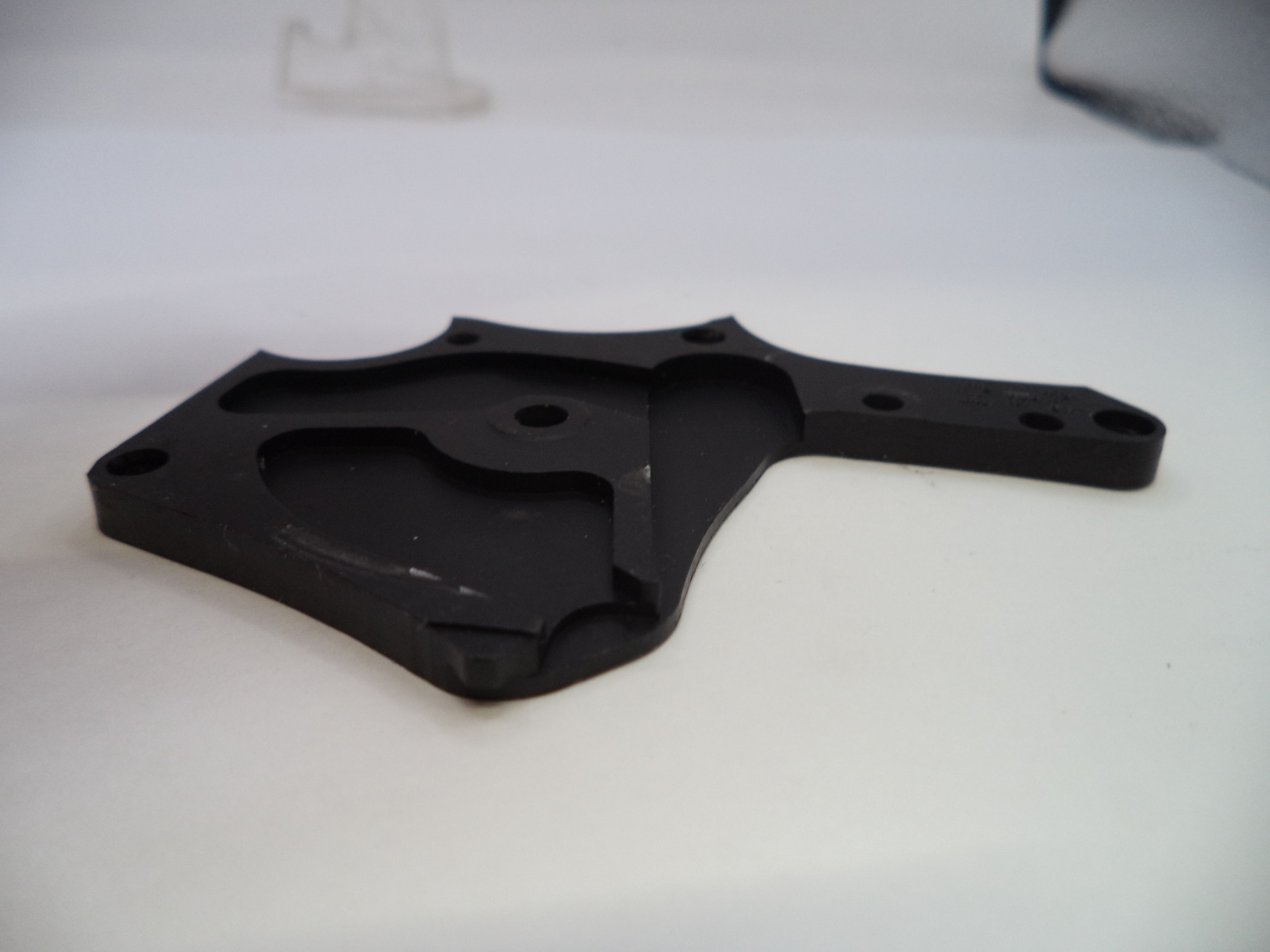 Black plastic bracket on a white background