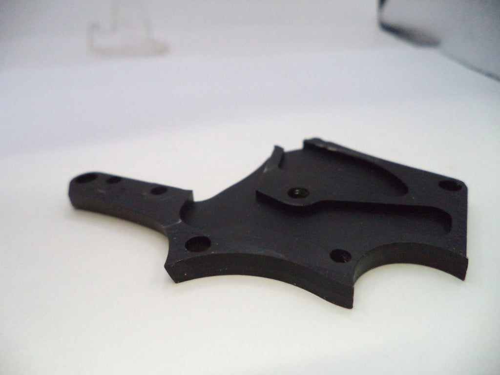 Black plastic component on a white background