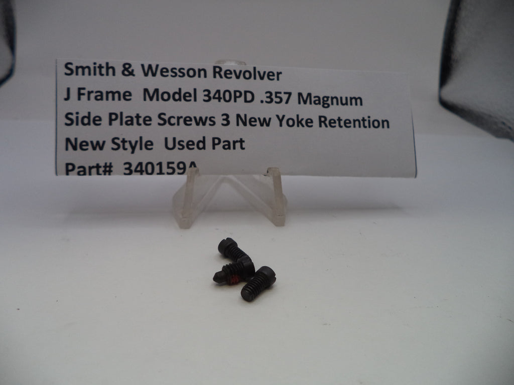 Three black screws on a white surface with a label describing them.