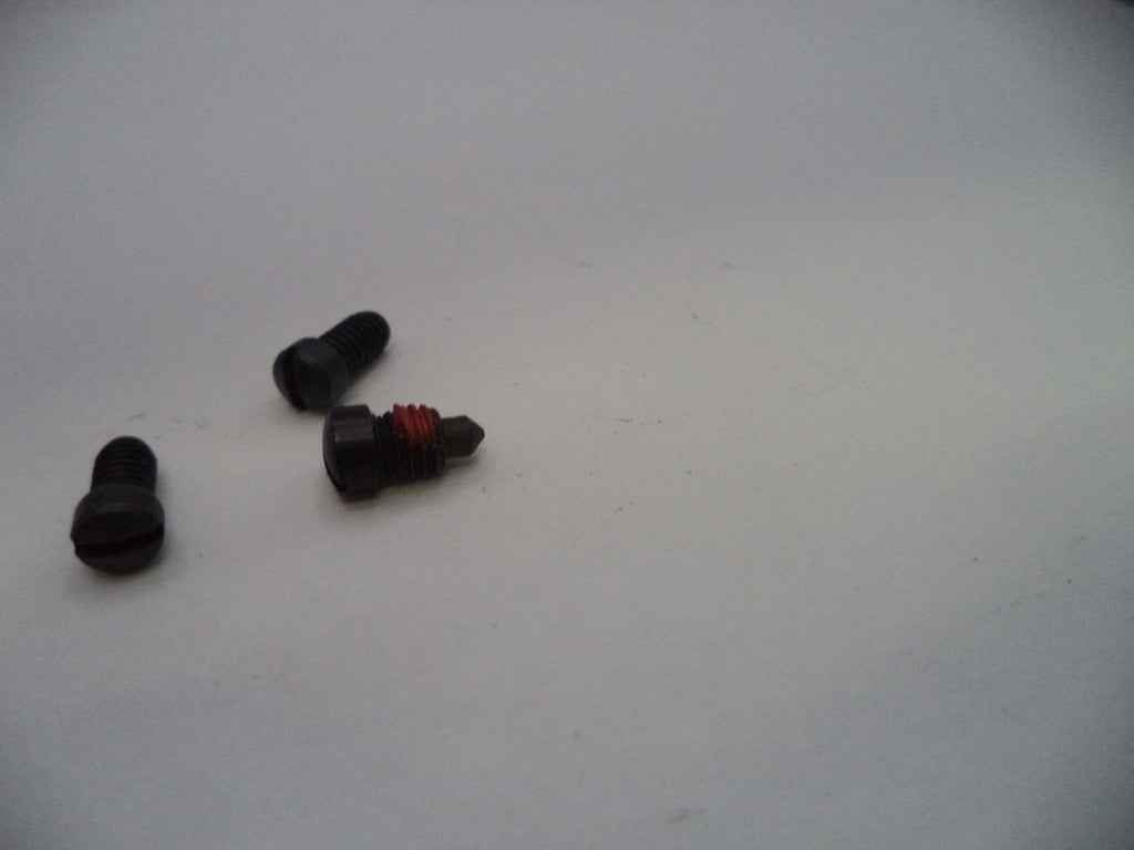 Three small mechanical parts on a white surface