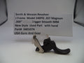 Trigger mechanism of a Smith & Wesson revolver with a label on a white background