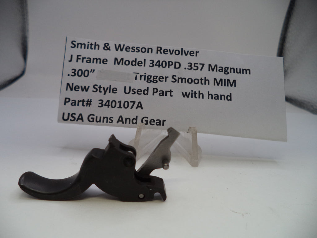 Smith & Wesson revolver trigger part with descriptive card on a white background