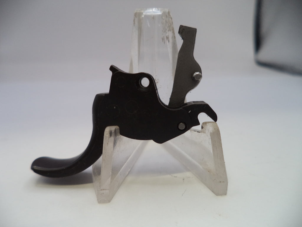Black metal bracket on a clear plastic stand against a white background