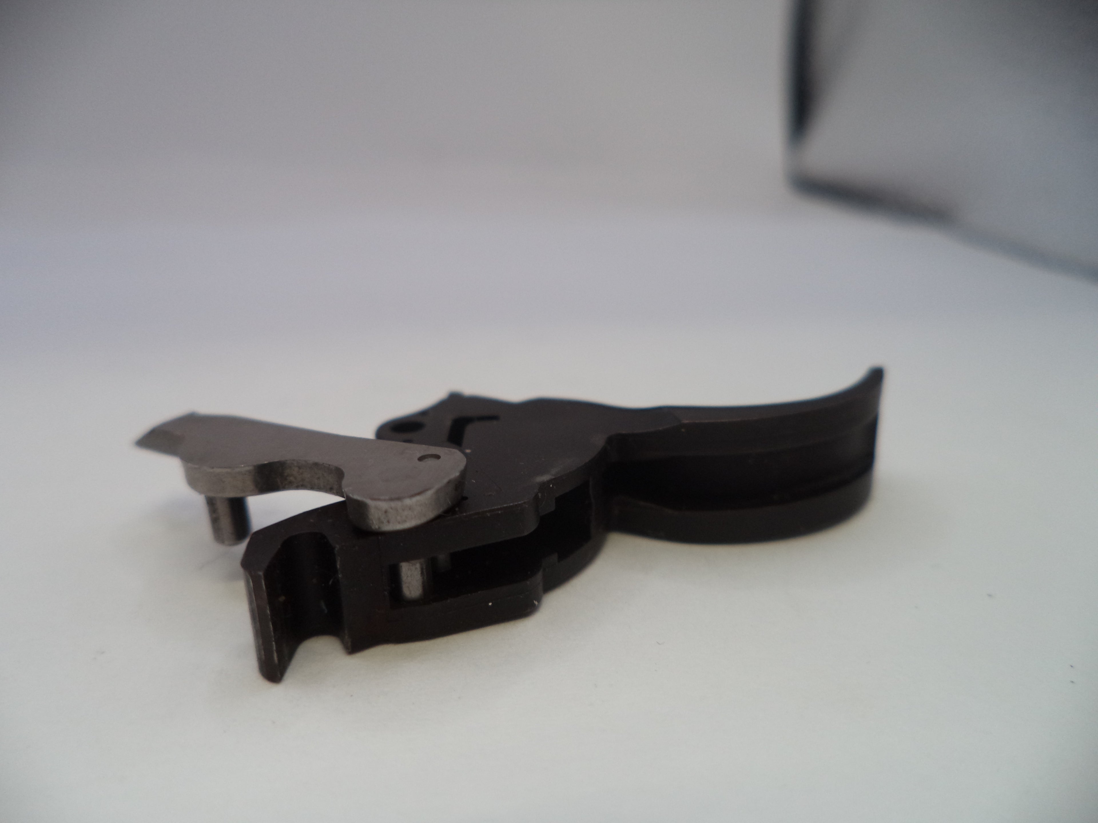 Black metal butterfly-shaped tool on a white surface