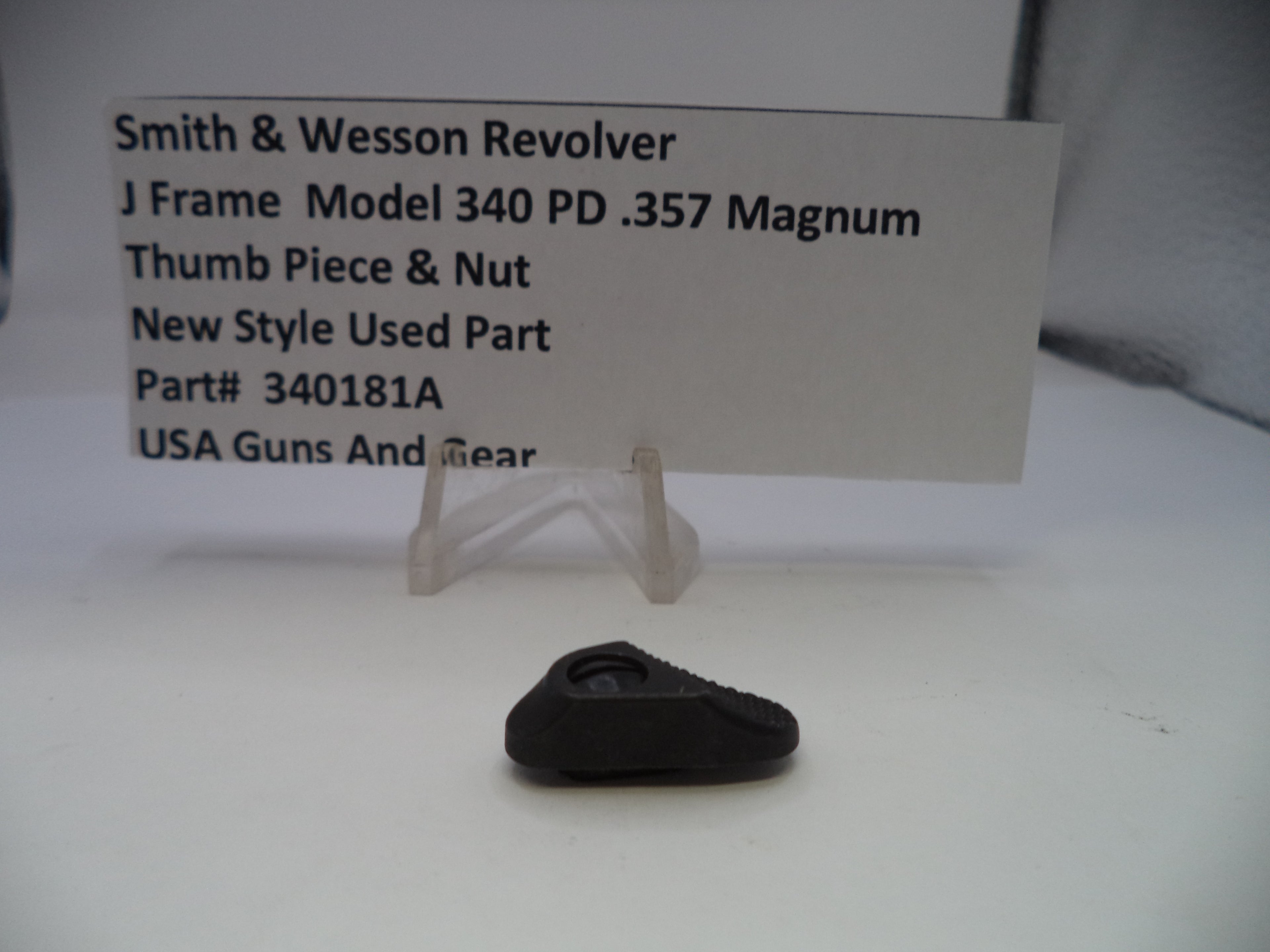 Black thumb piece & nut for Smith & Wesson Revolver on a white card with product details.