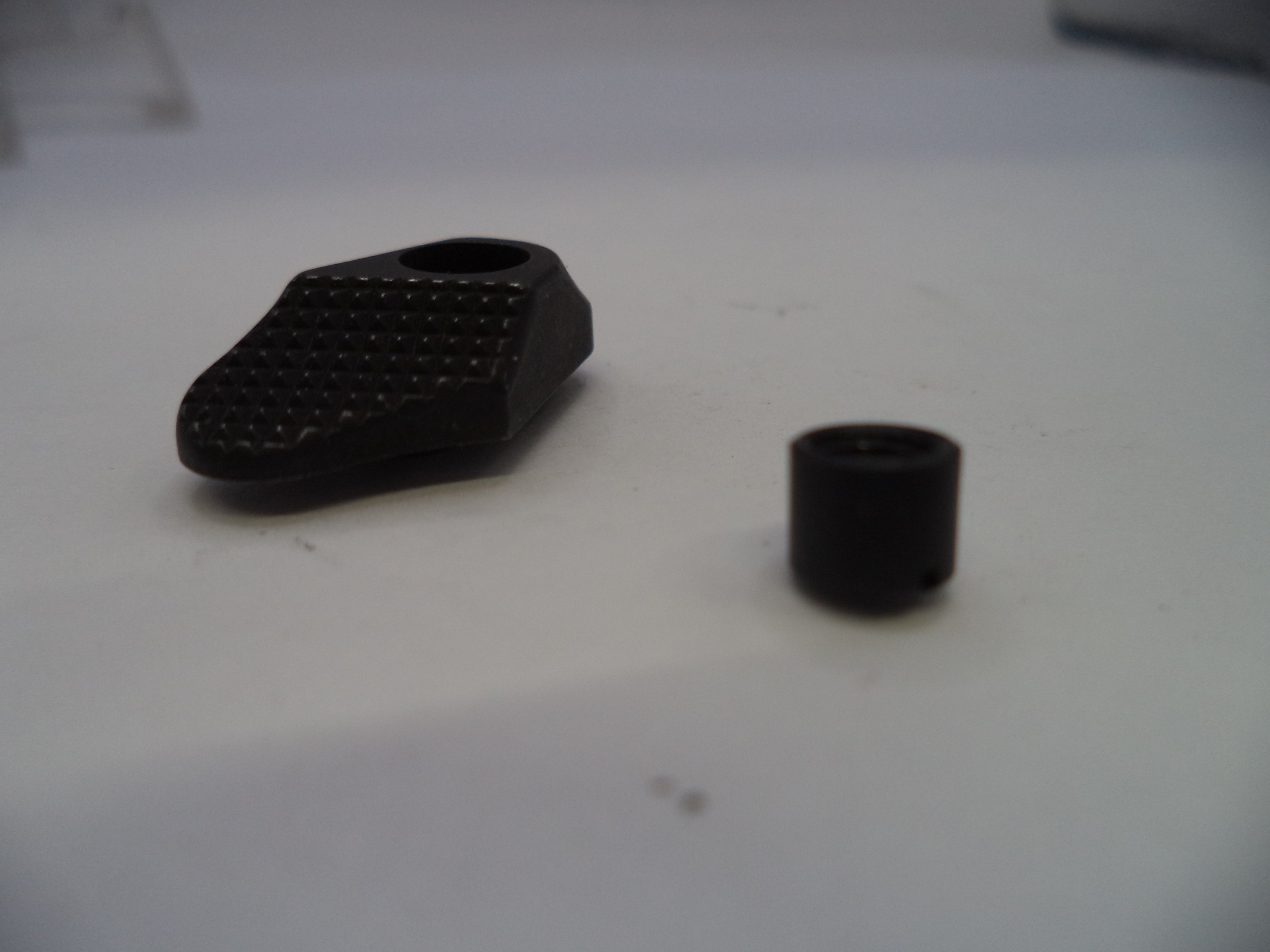 Two black cylindrical objects on a white surface
