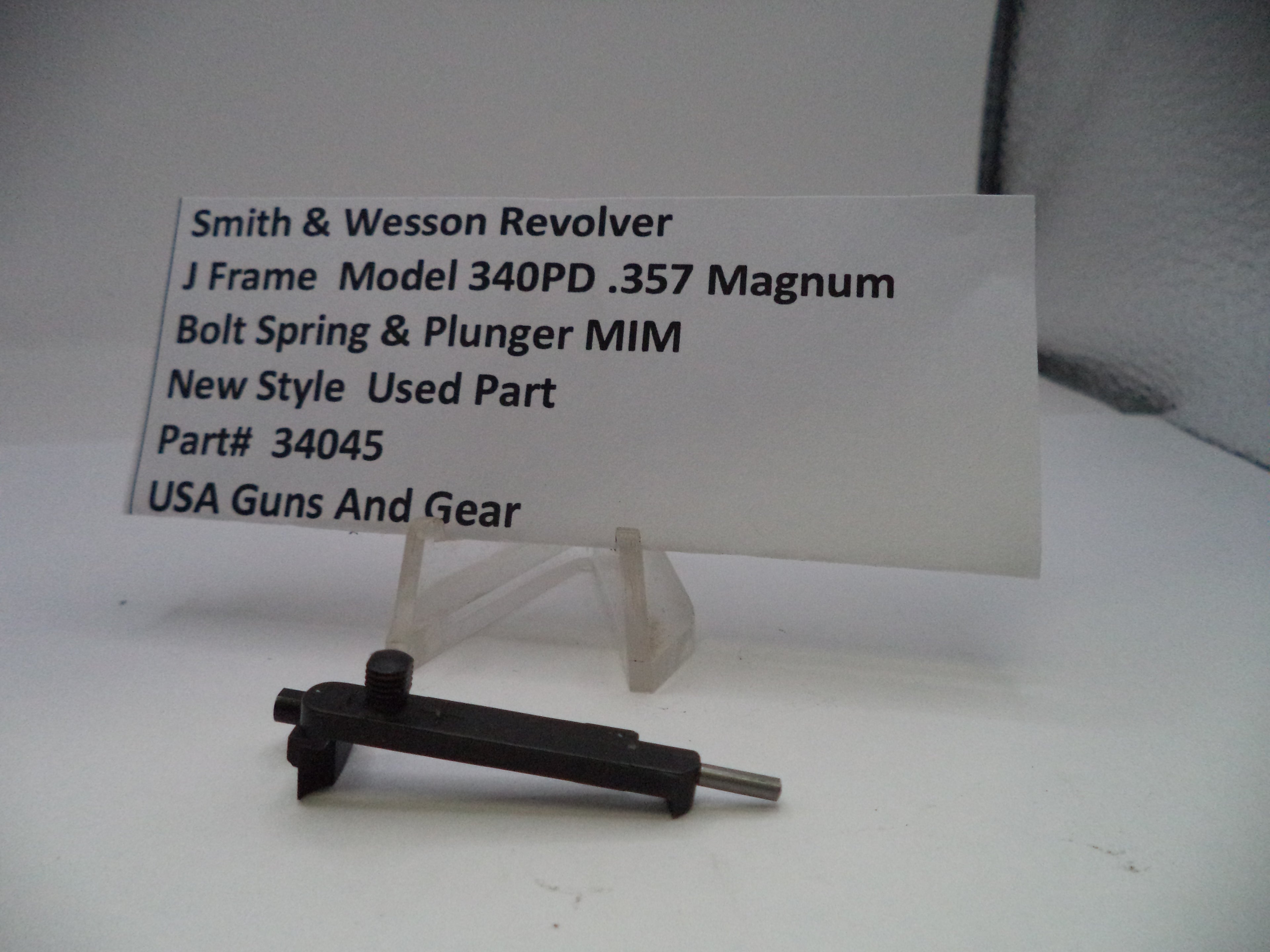 Smith & Wesson revolver part with descriptive card on a white background