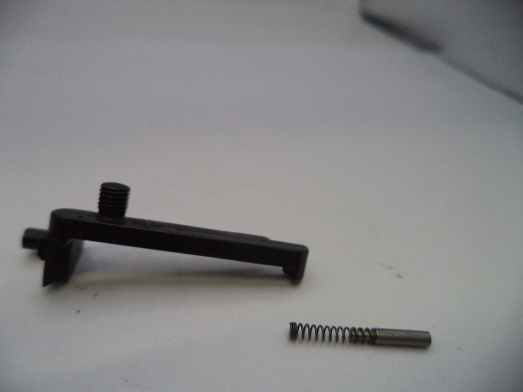 Black mechanical component and spring on a white surface