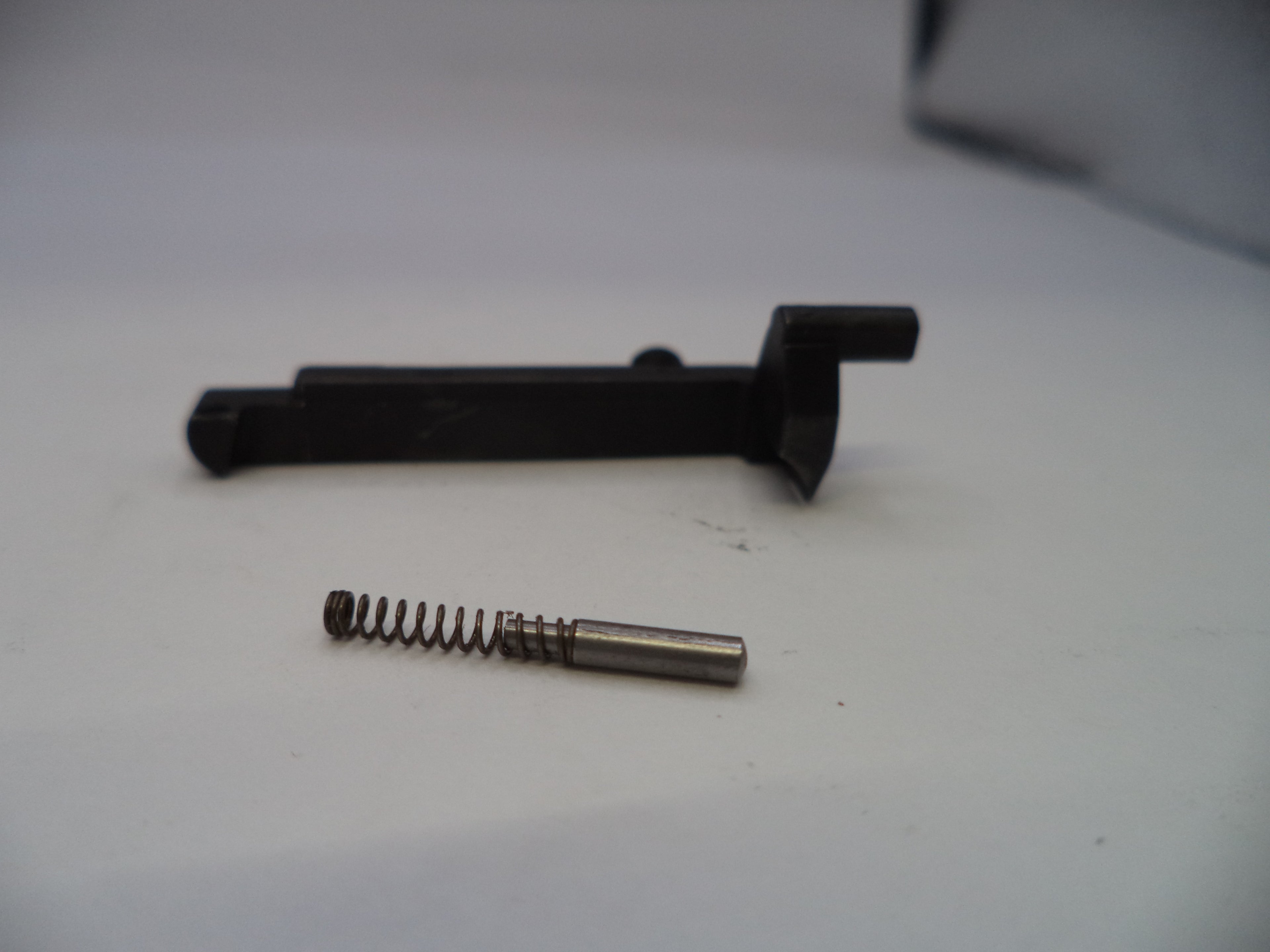 Black metal lever and spring on a white background