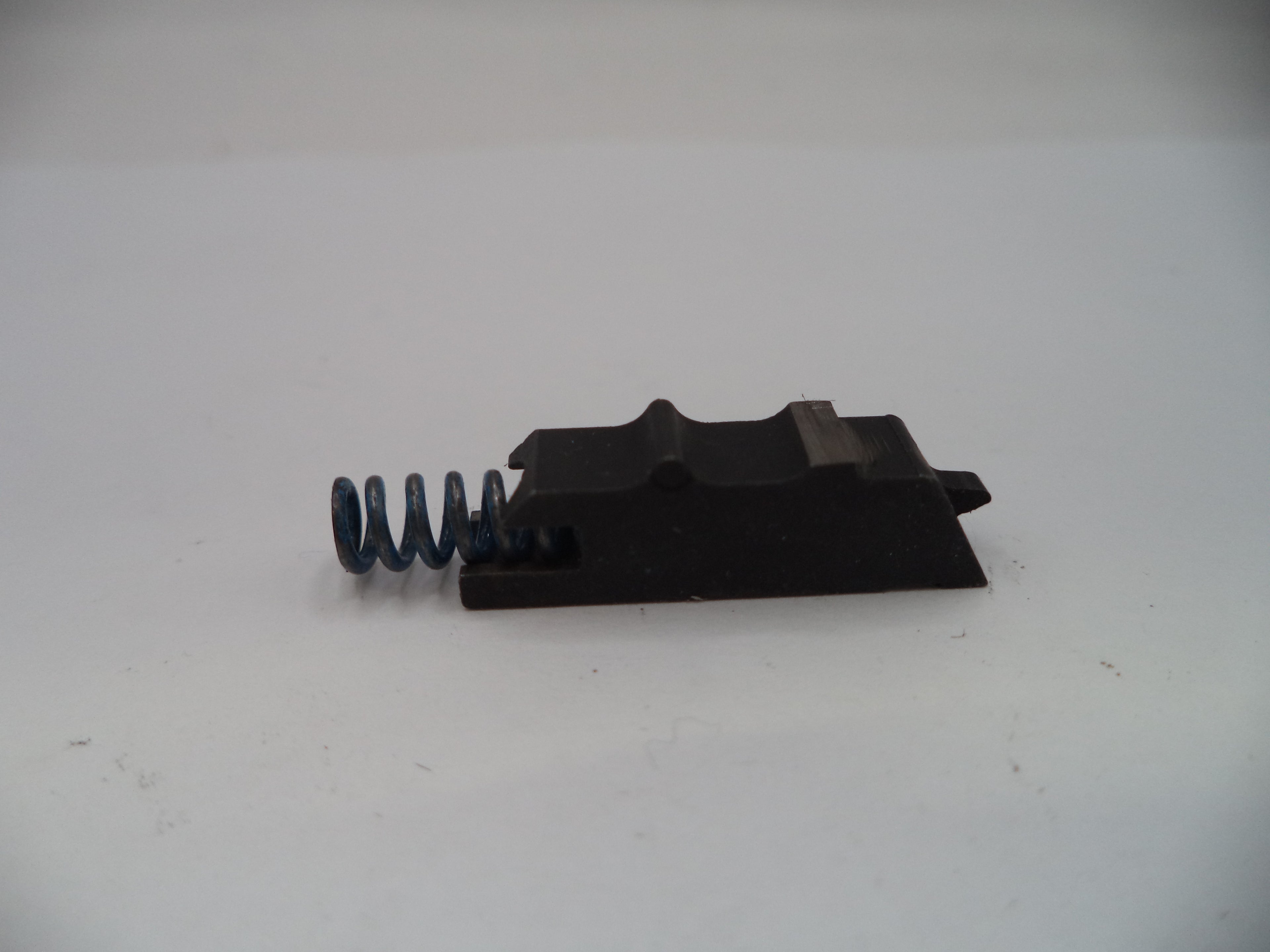 Mechanical component with a spring on a white background
