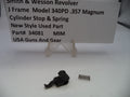 Smith & Wesson revolver cylinder stop and spring with a label on a white background