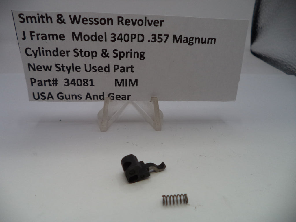 Smith & Wesson revolver cylinder stop and spring with a label on a white background