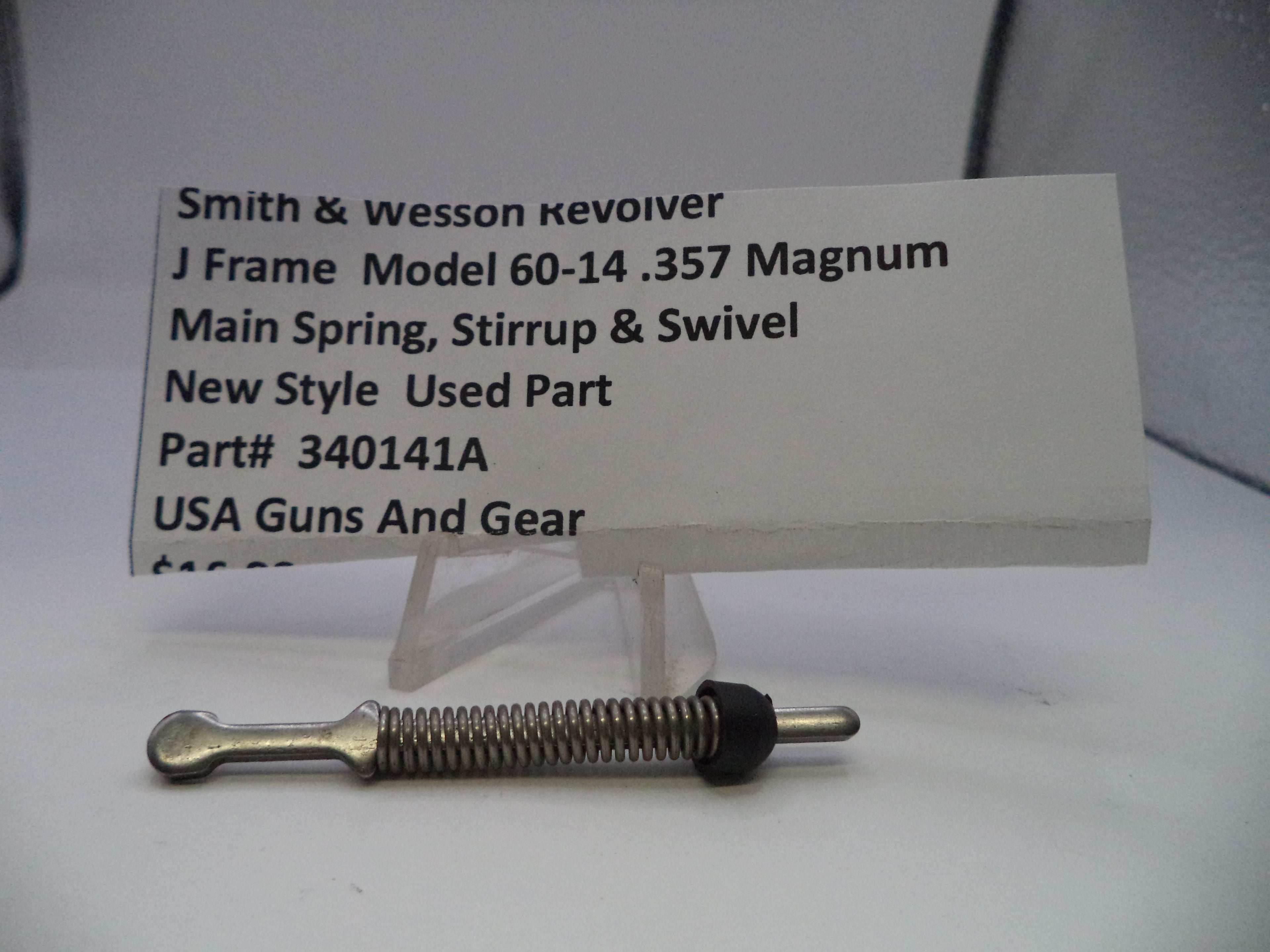 Smith & Wesson revolver part with descriptive card on a white background