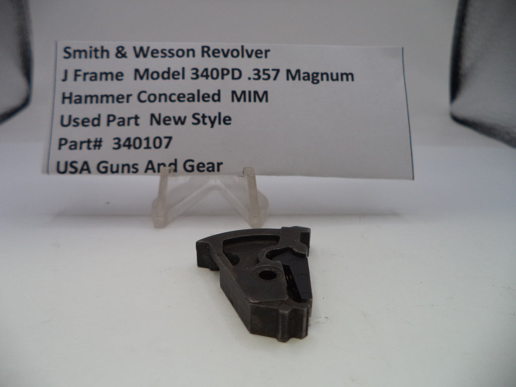 Black gun part with a label on a white background