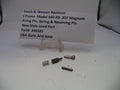 Smith & Wesson revolver parts including a firing pin, spring, and retaining pin on a white surface with a label.