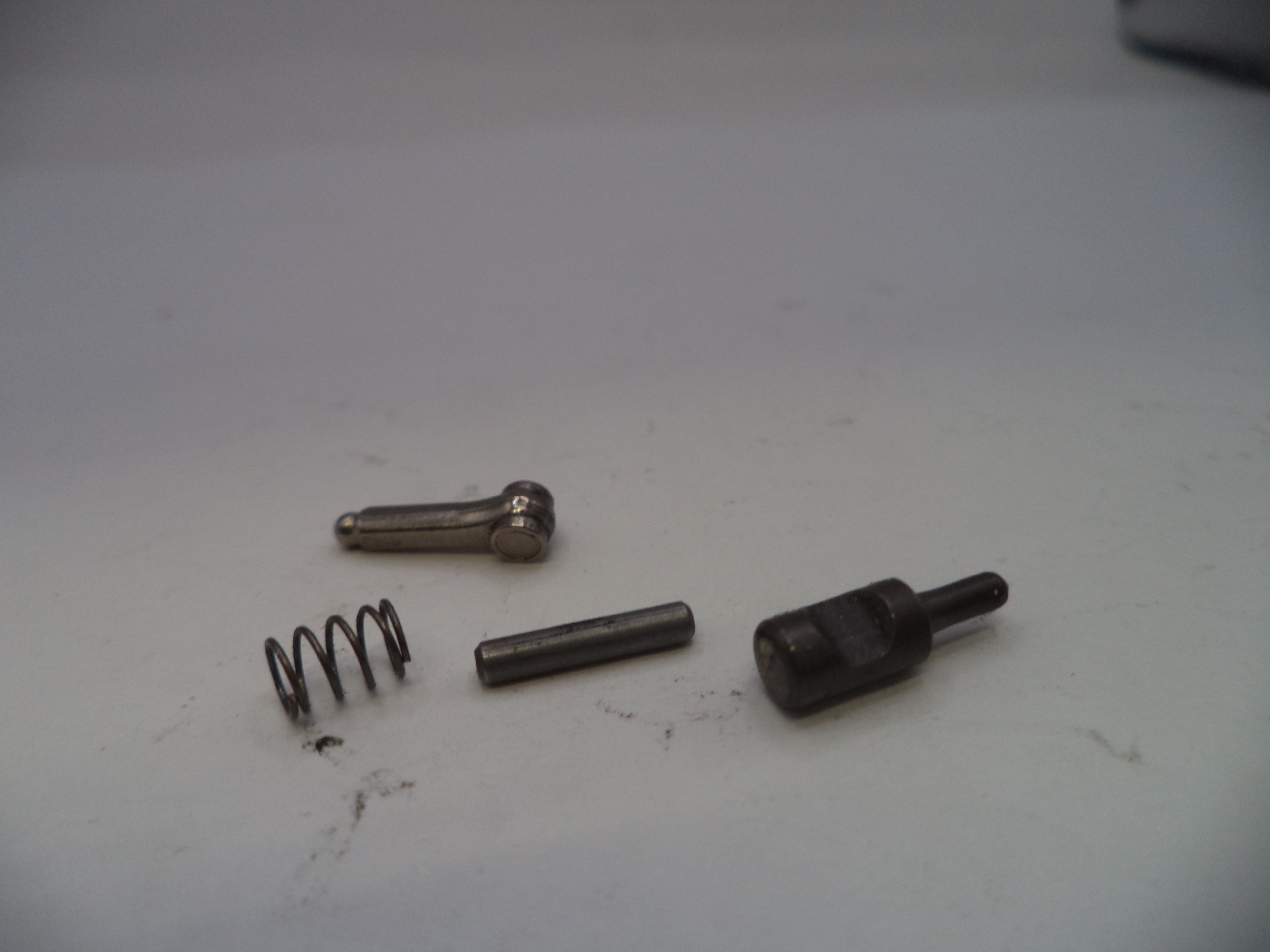 Four mechanical parts on a white surface