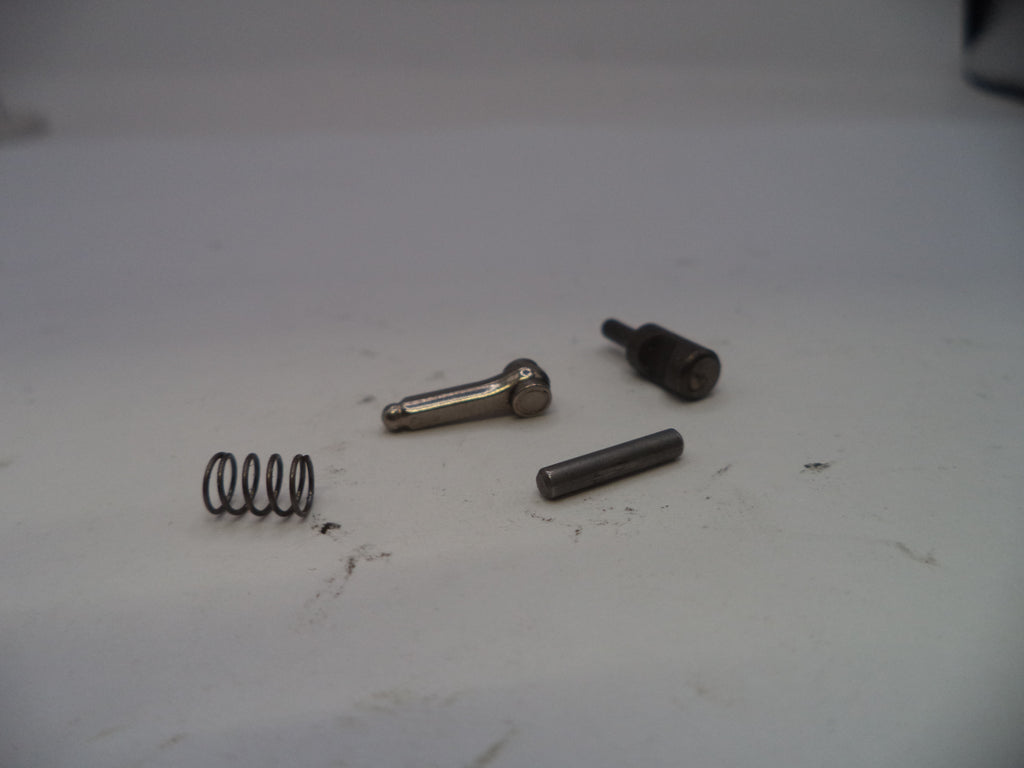 Four metal components on a white surface