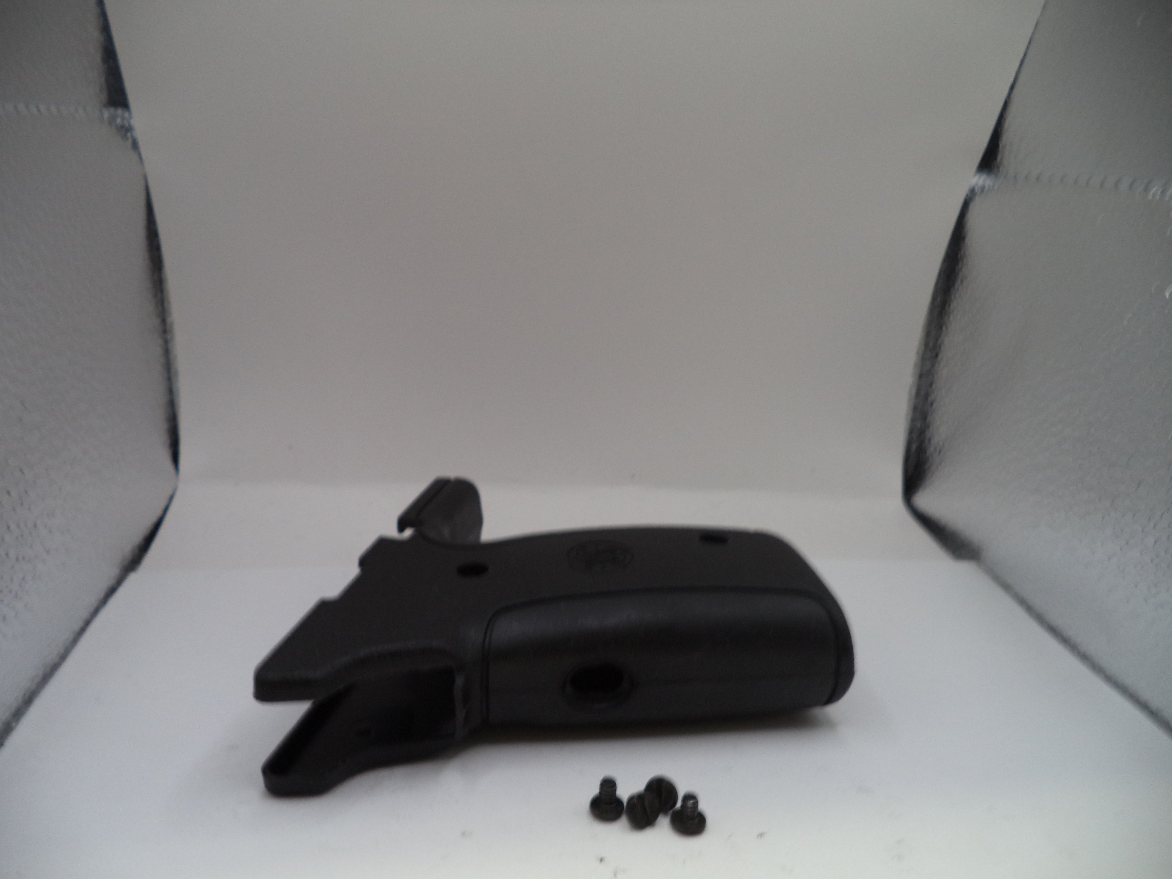 Black firearm part on a white background