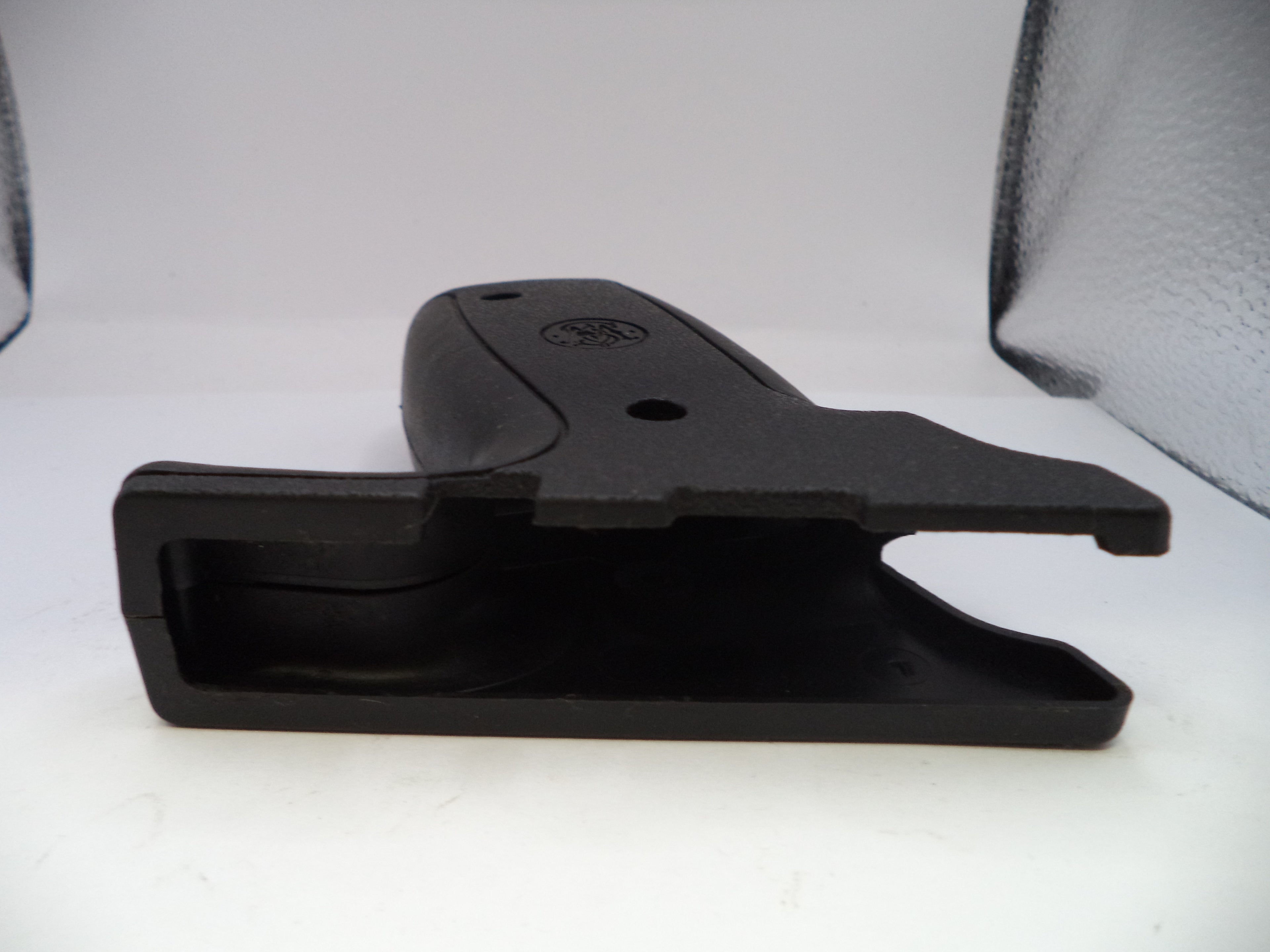 Black plastic component on a white background