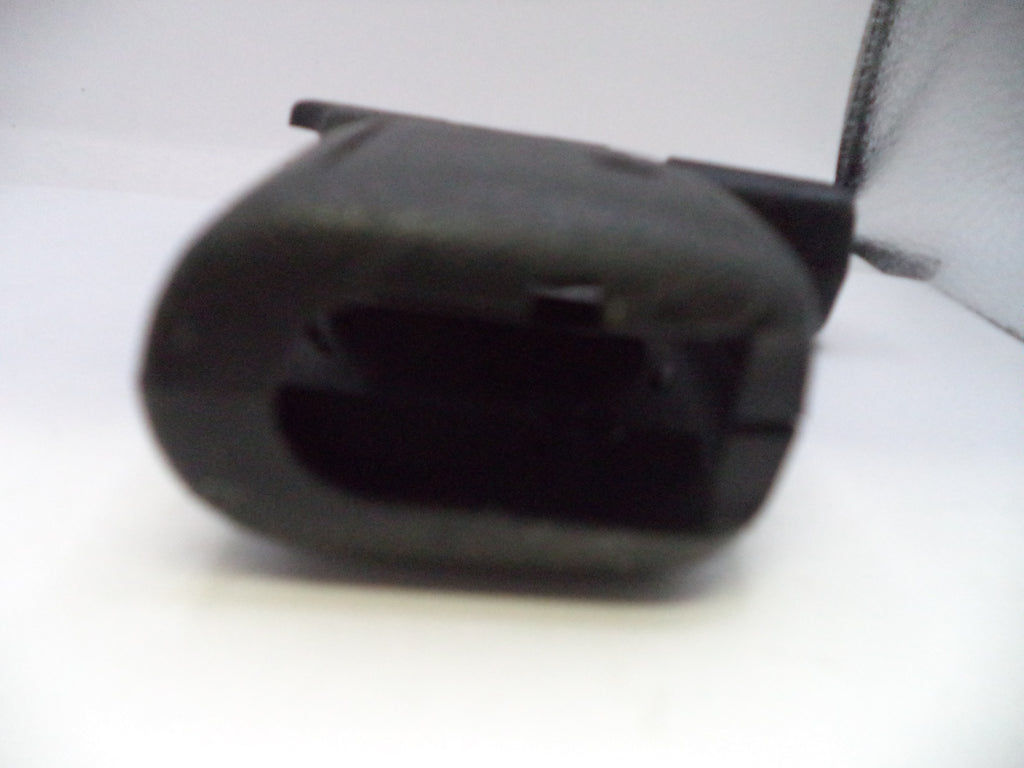 Black plastic component on a white background