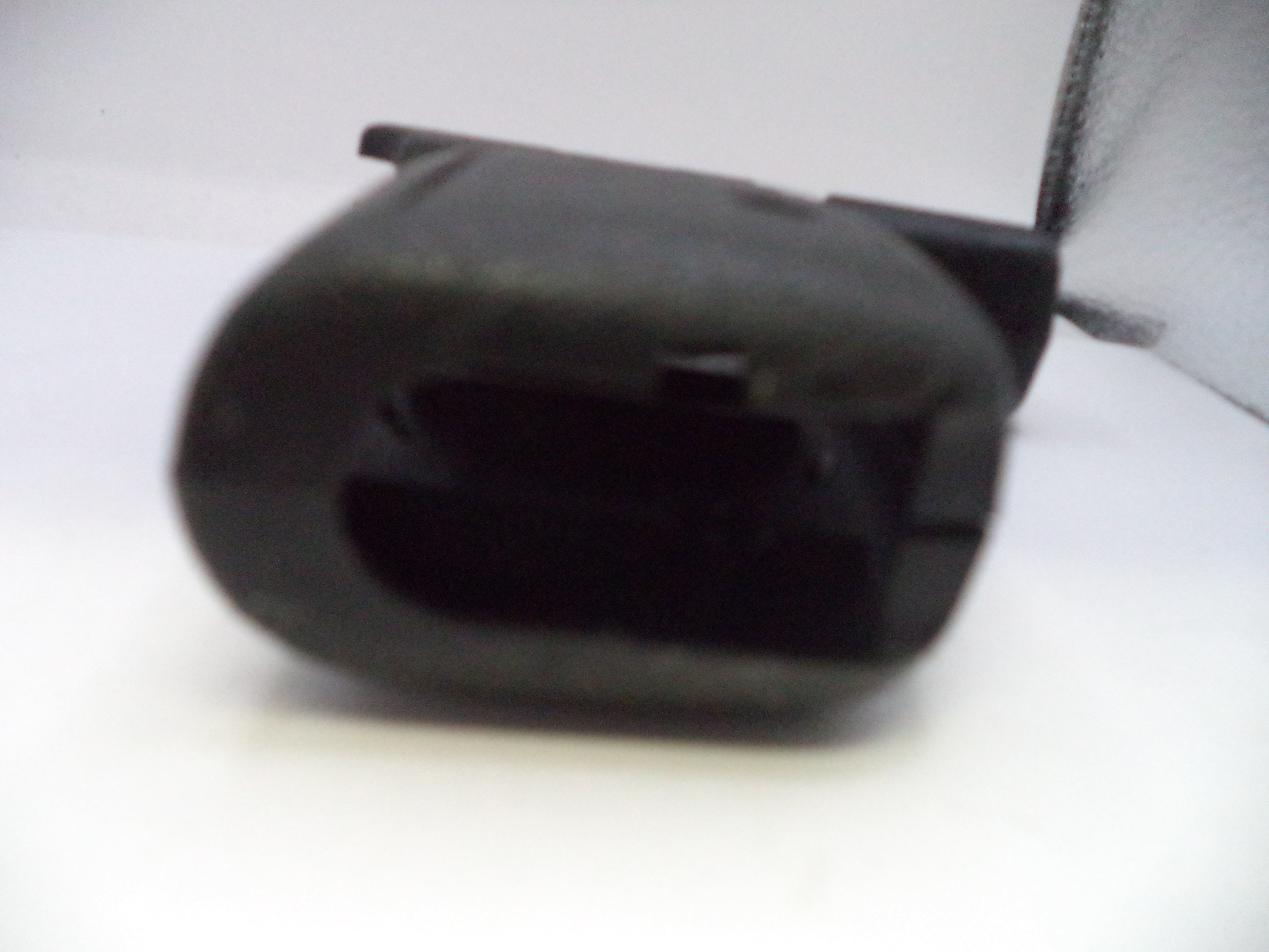 Black plastic component on a white background