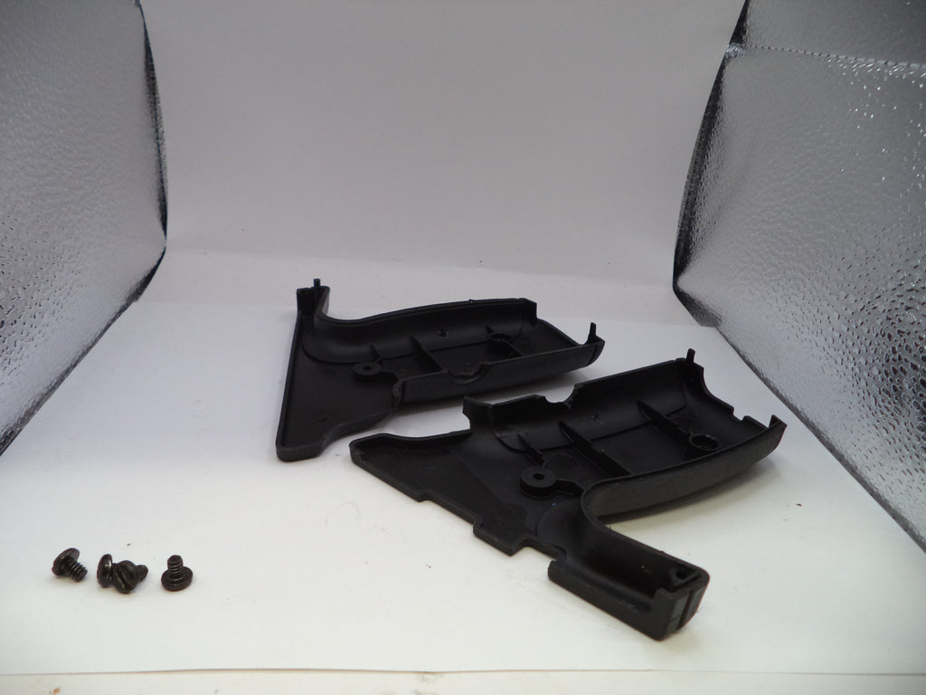 Black plastic automotive parts on a white background