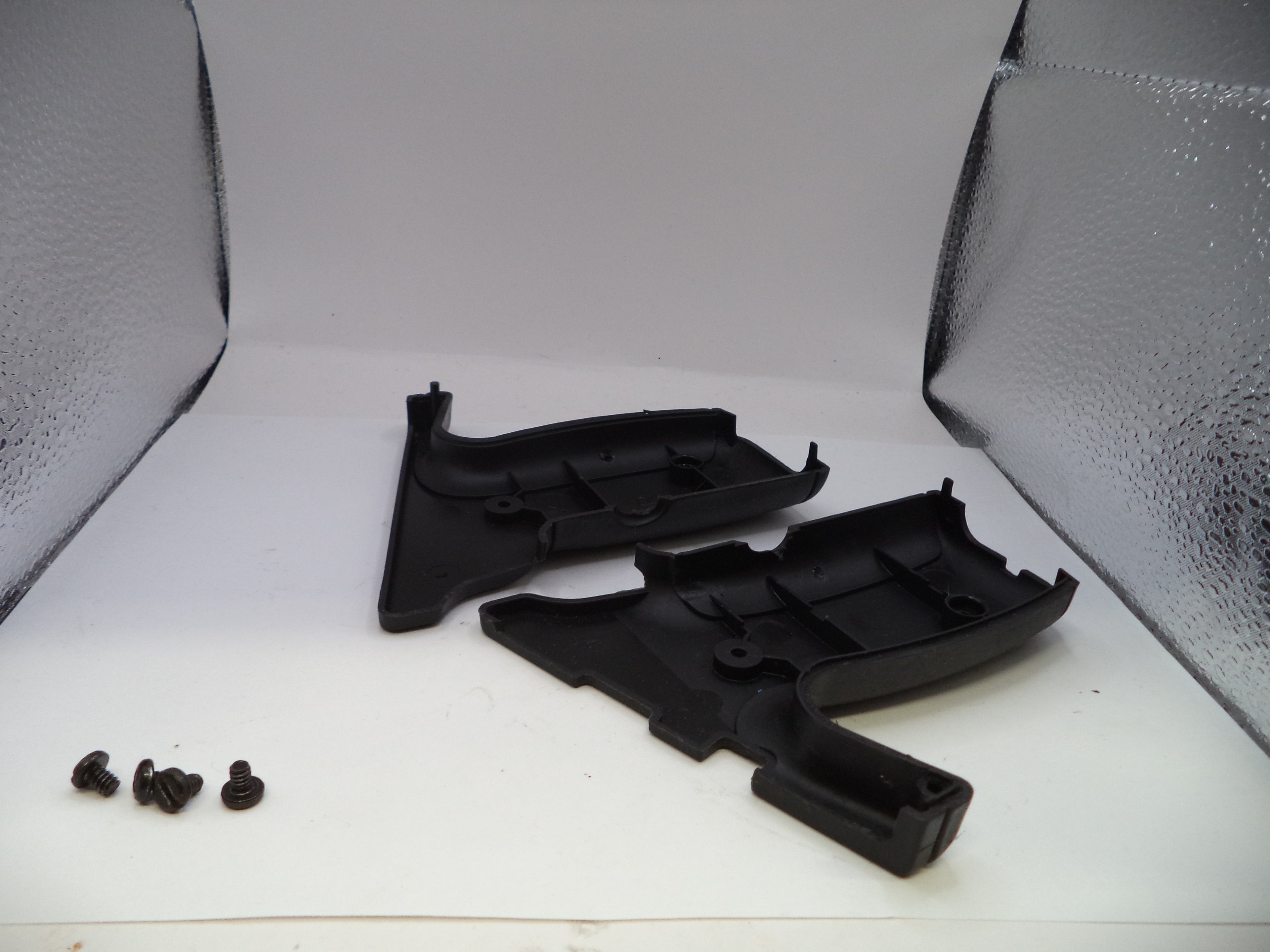 Black plastic automotive parts on a white background