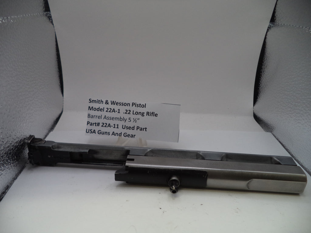 Smith & Wesson pistol barrel assembly on a white surface with a label.