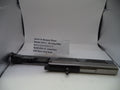 Smith & Wesson pistol barrel assembly on a white surface with a label.