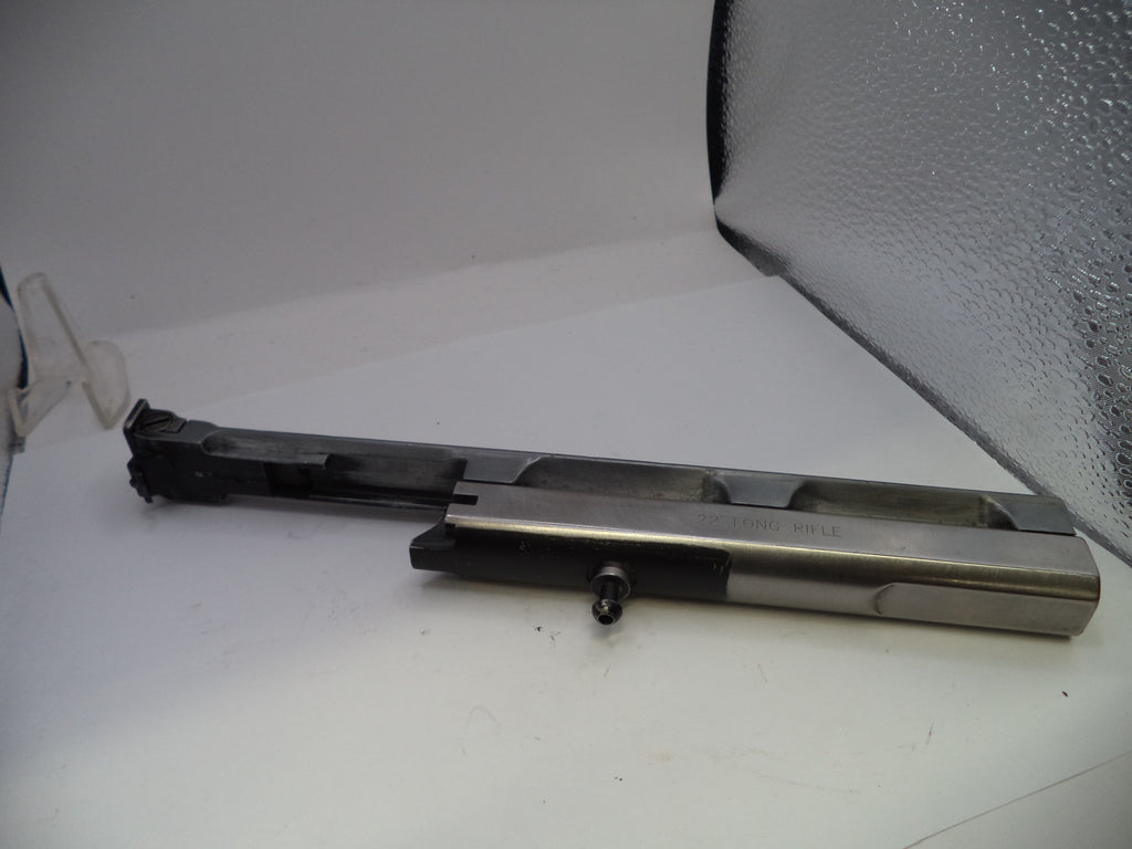 Metal component on a white surface with a textured gray background