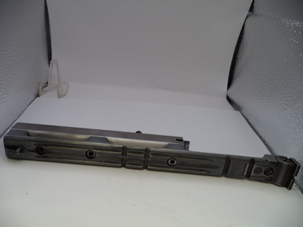 Metallic object on a white surface with a textured background