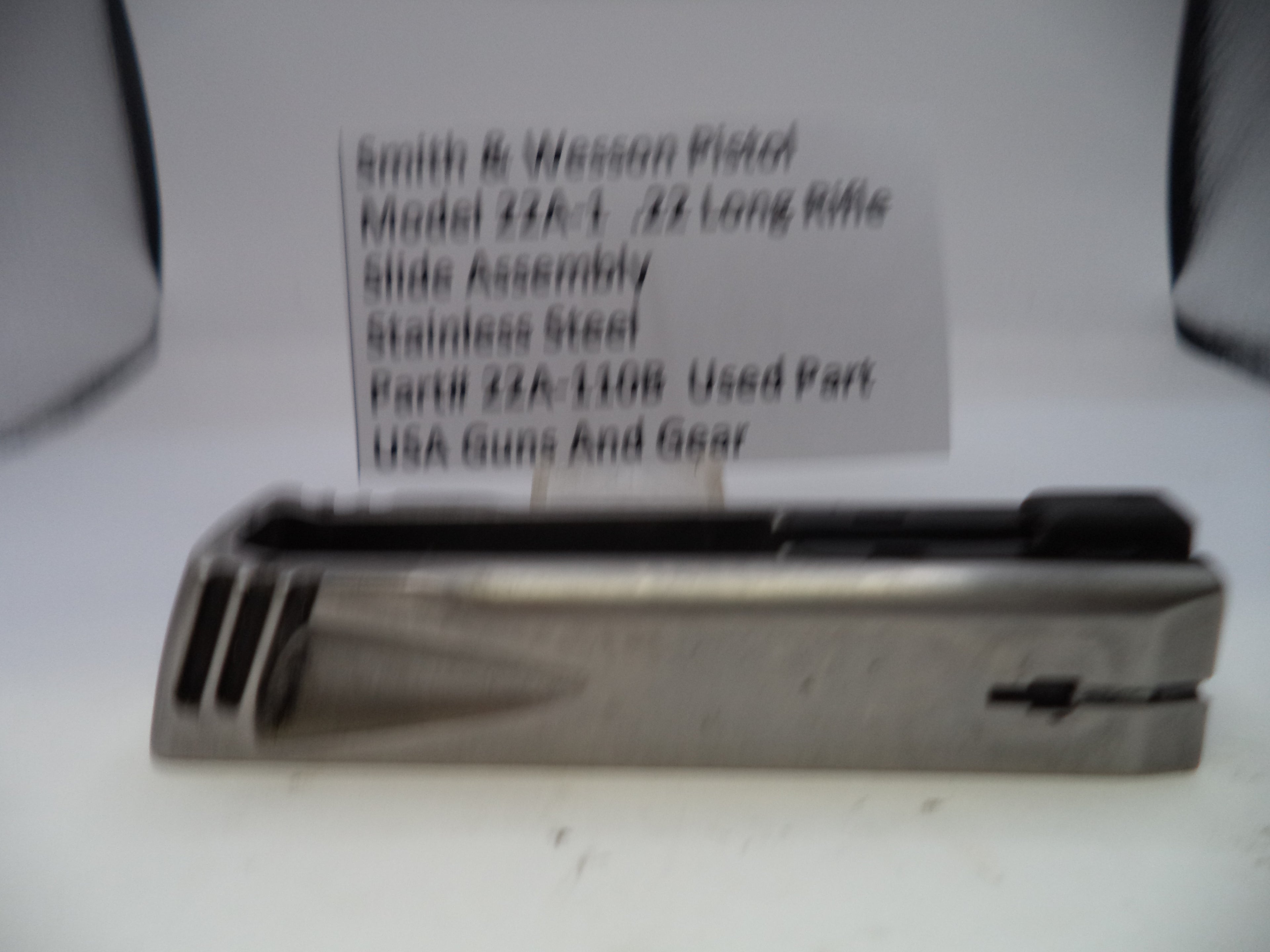 Smith & Wesson pistol slide assembly with label on a white background