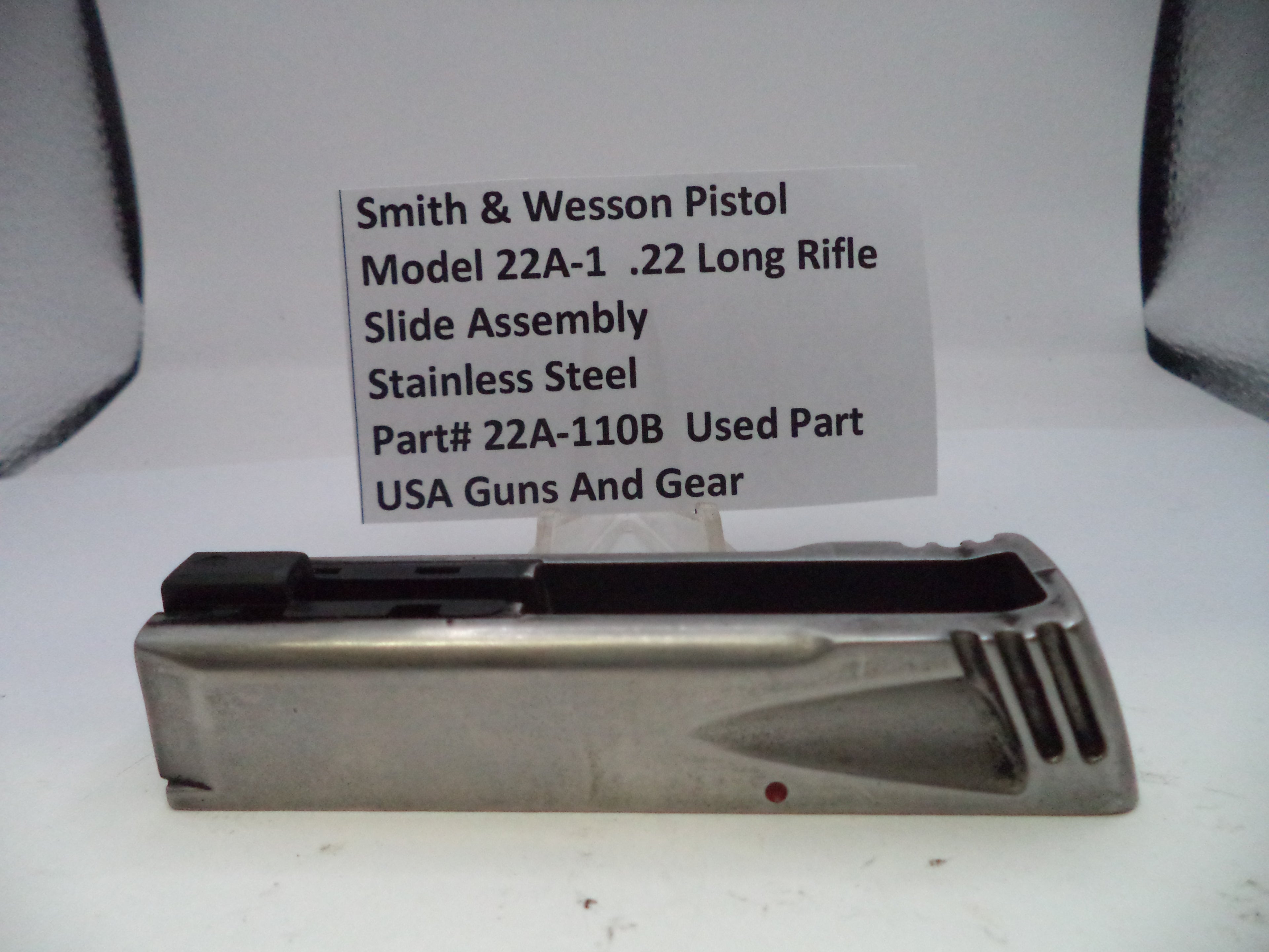 Smith & Wesson pistol slide assembly on a white background with a label.