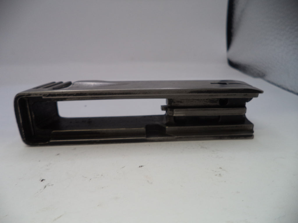 Metal bracket on a white surface with a gray background