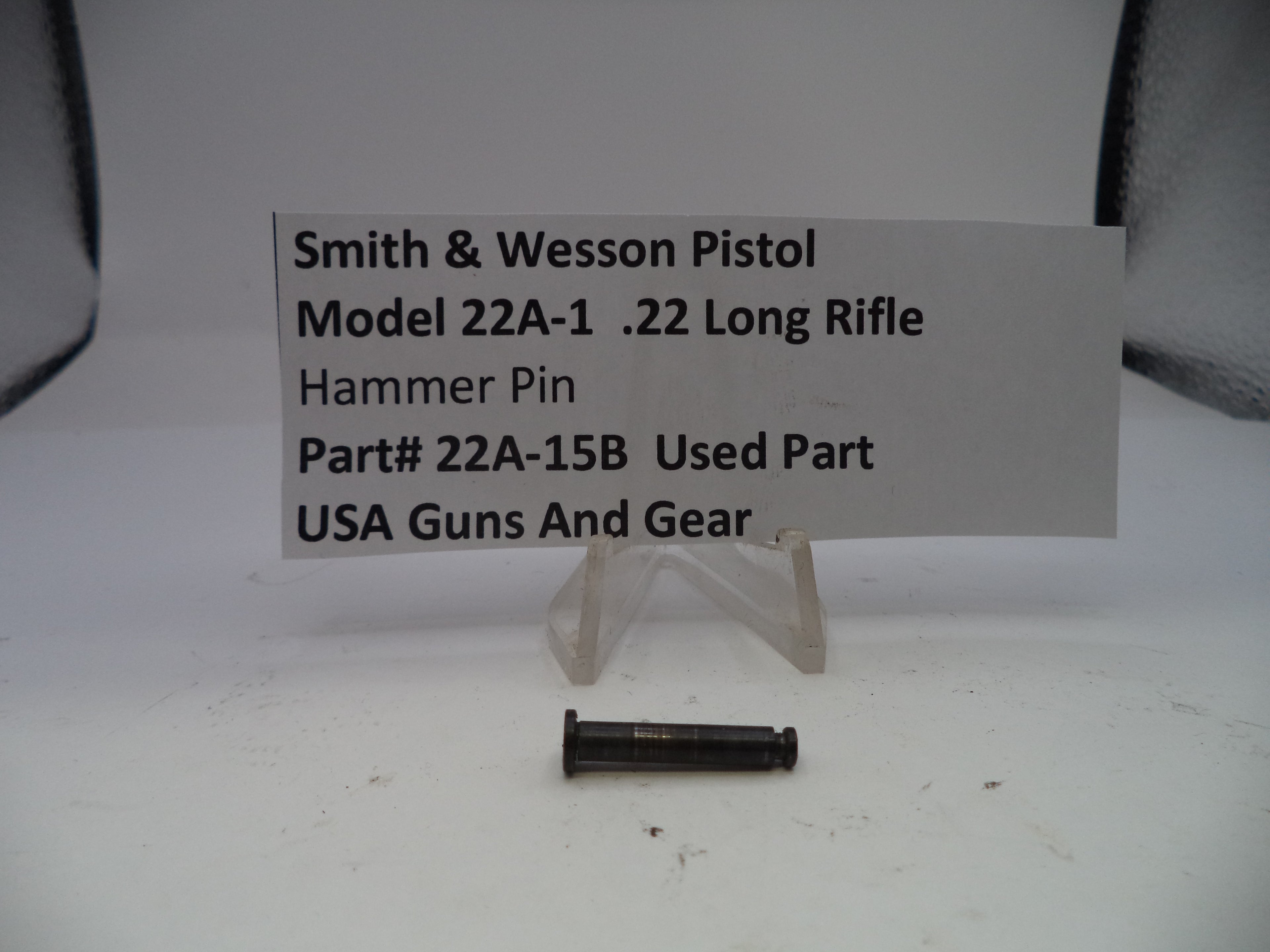 Smith & Wesson pistol part on a white background with a label