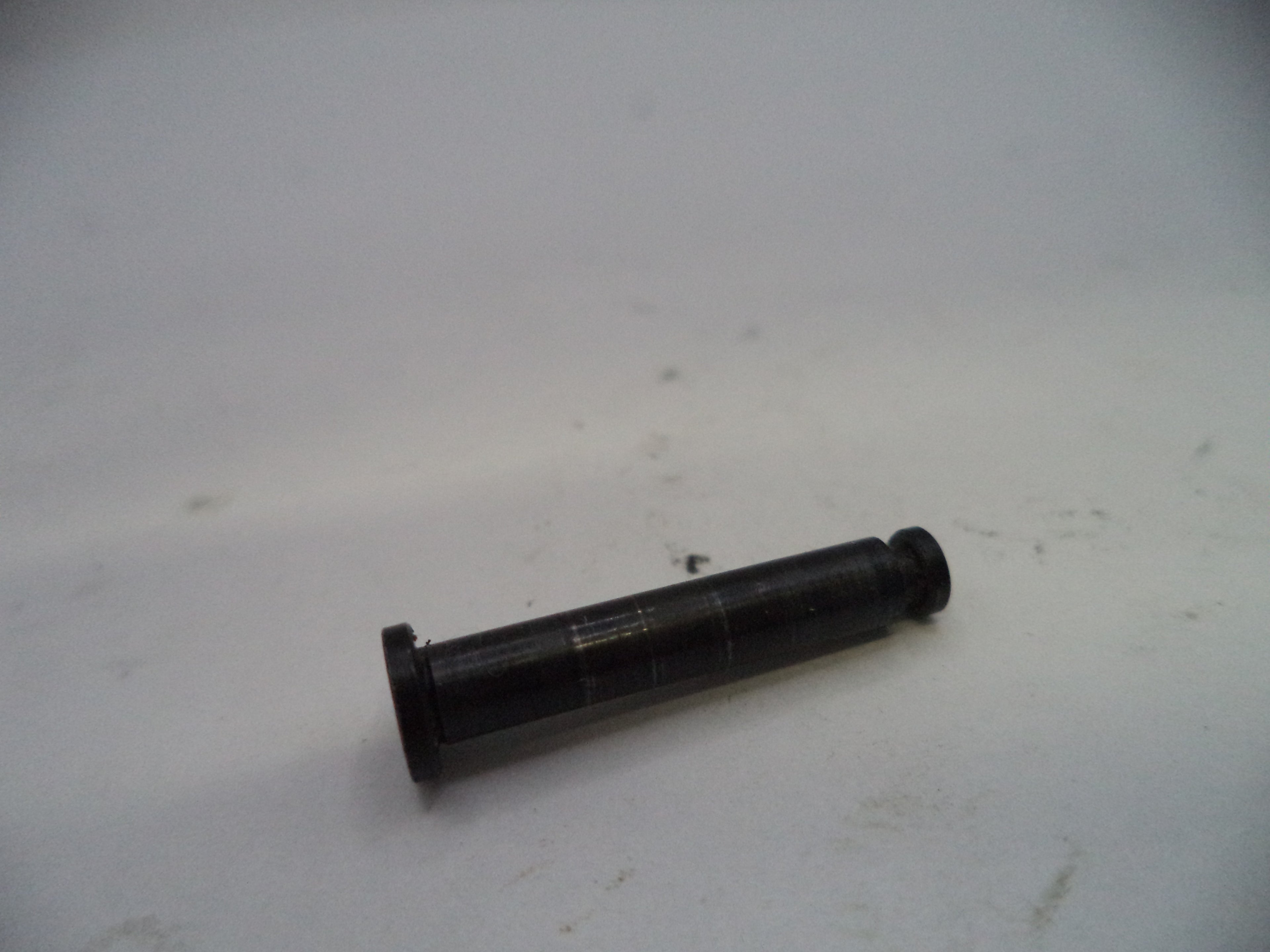 Black cylindrical object on a white surface