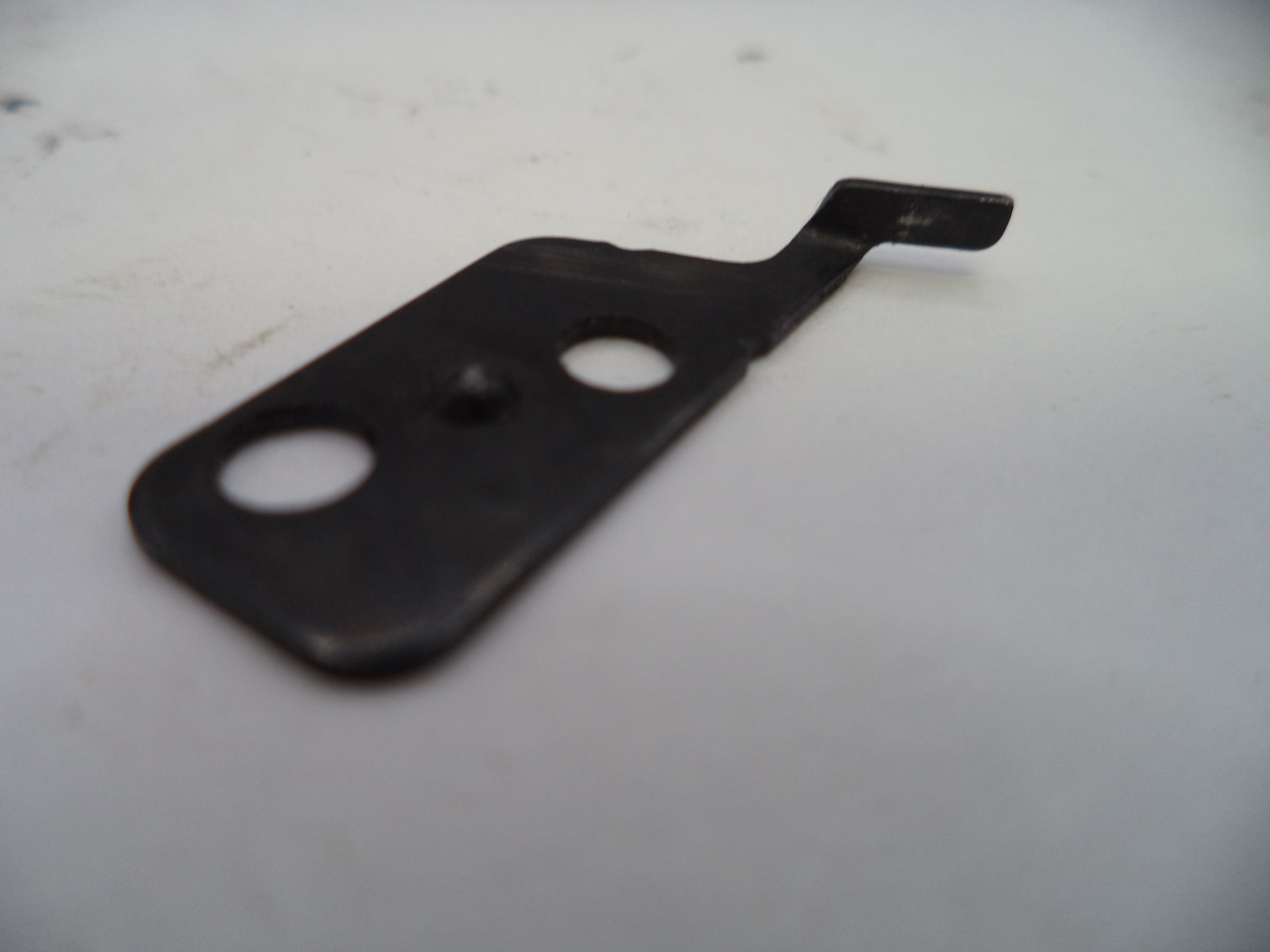 Black metal bracket with two holes on a white background
